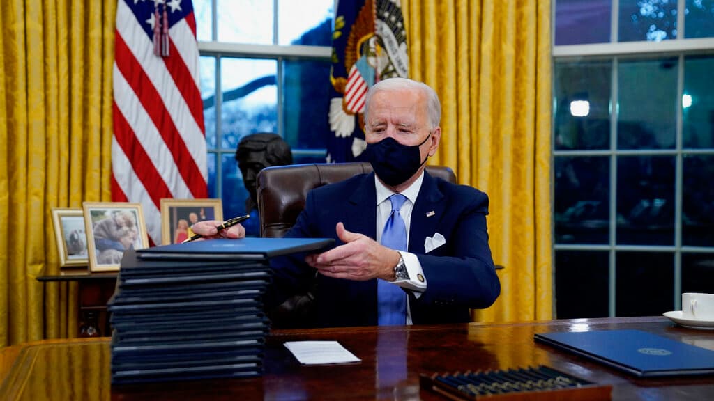 President Joe Biden signs his first executive orders in the Oval Office of the White House in Washington on Jan. 20, 2021. Six of Biden's 17 first-day executive orders dealt with immigration, such as halting work on a border wall in Mexico and lifting a t