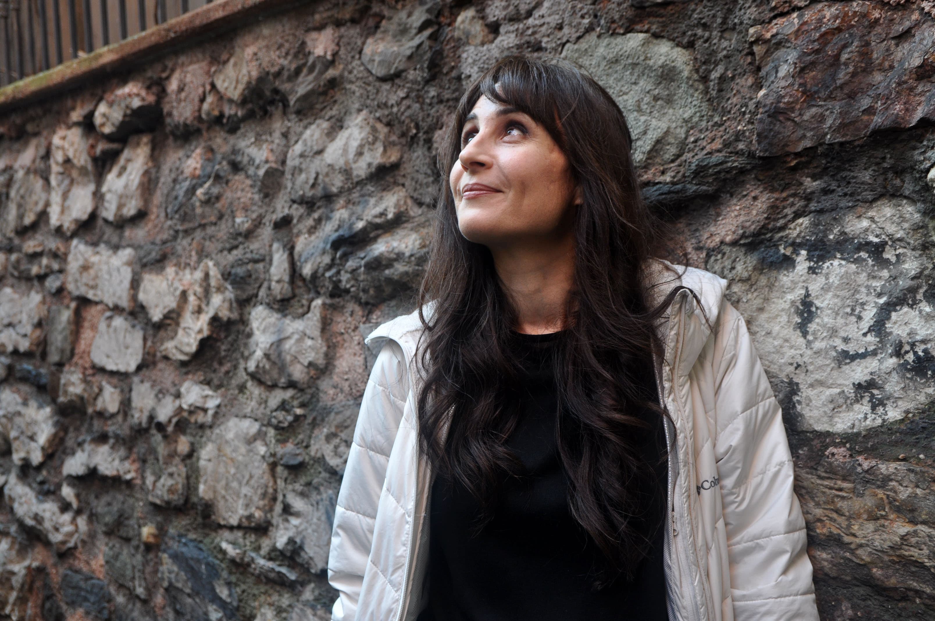 Nektaria Anastasiadou stands for a portrait in a small alleyway, that allows foot traffic to pass back towards the residential part of Çukurcuma from the busy main row of shops.