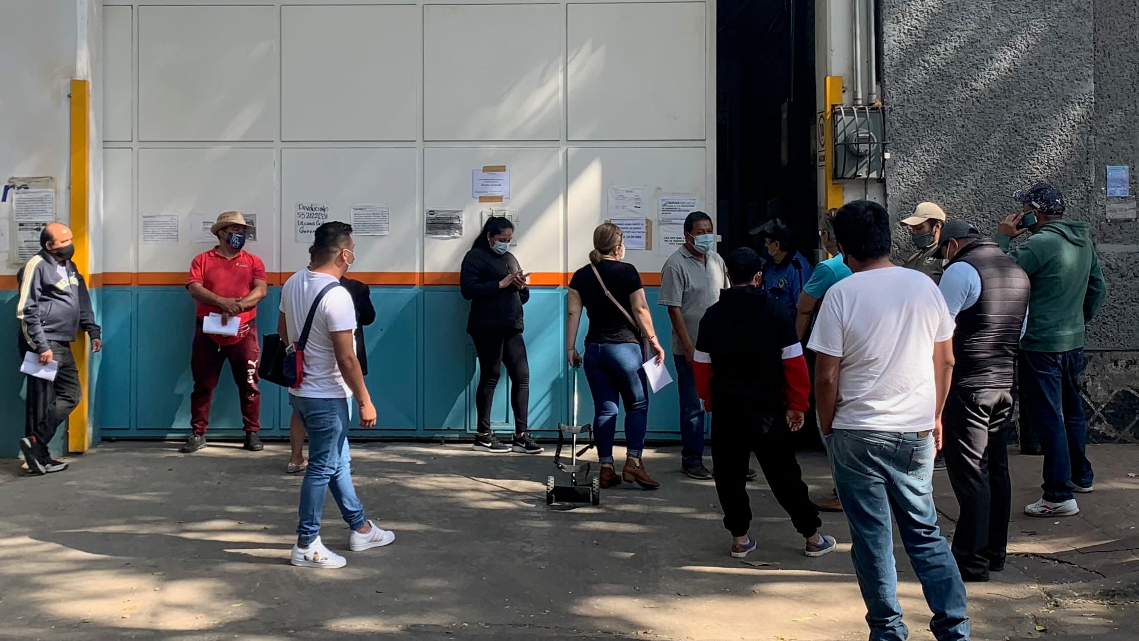 People wait in a long line at an oxygen distribution warehouse near downtown Mexico City.