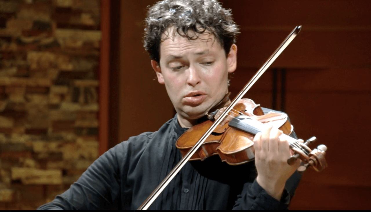 A man holds a violin