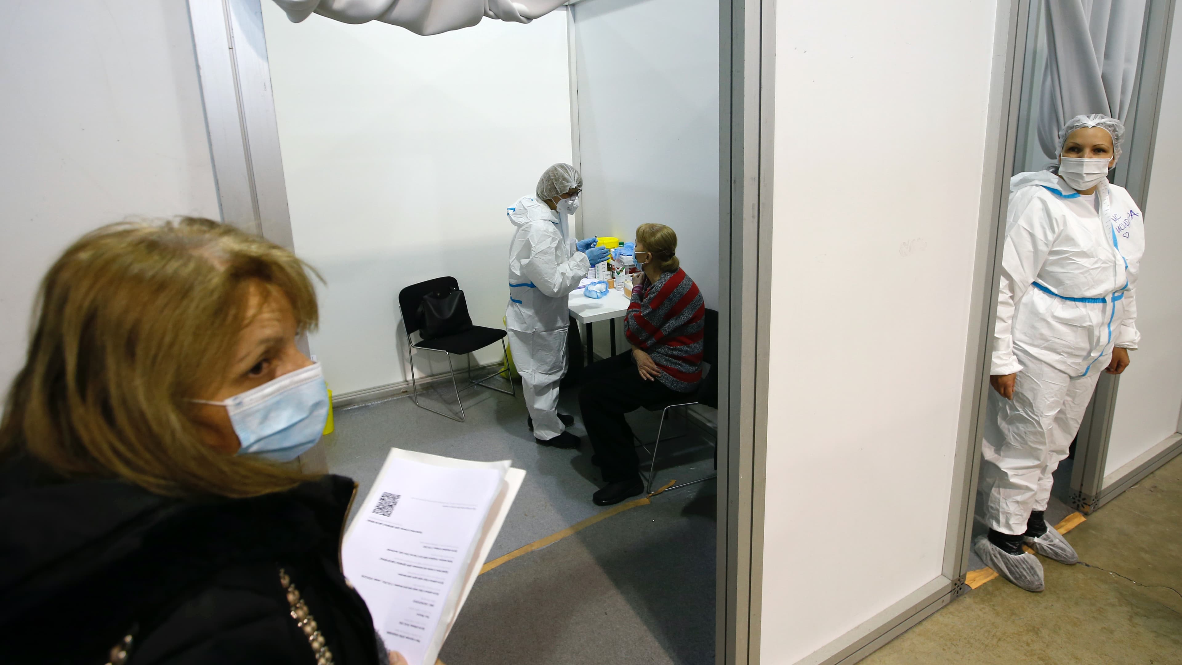 A medical worker gives a shot of the Chinese Sinopharm COVID-19 vaccine to a woman during the vaccination in Belgrade, Serbia, Feb. 17, 2021. 
