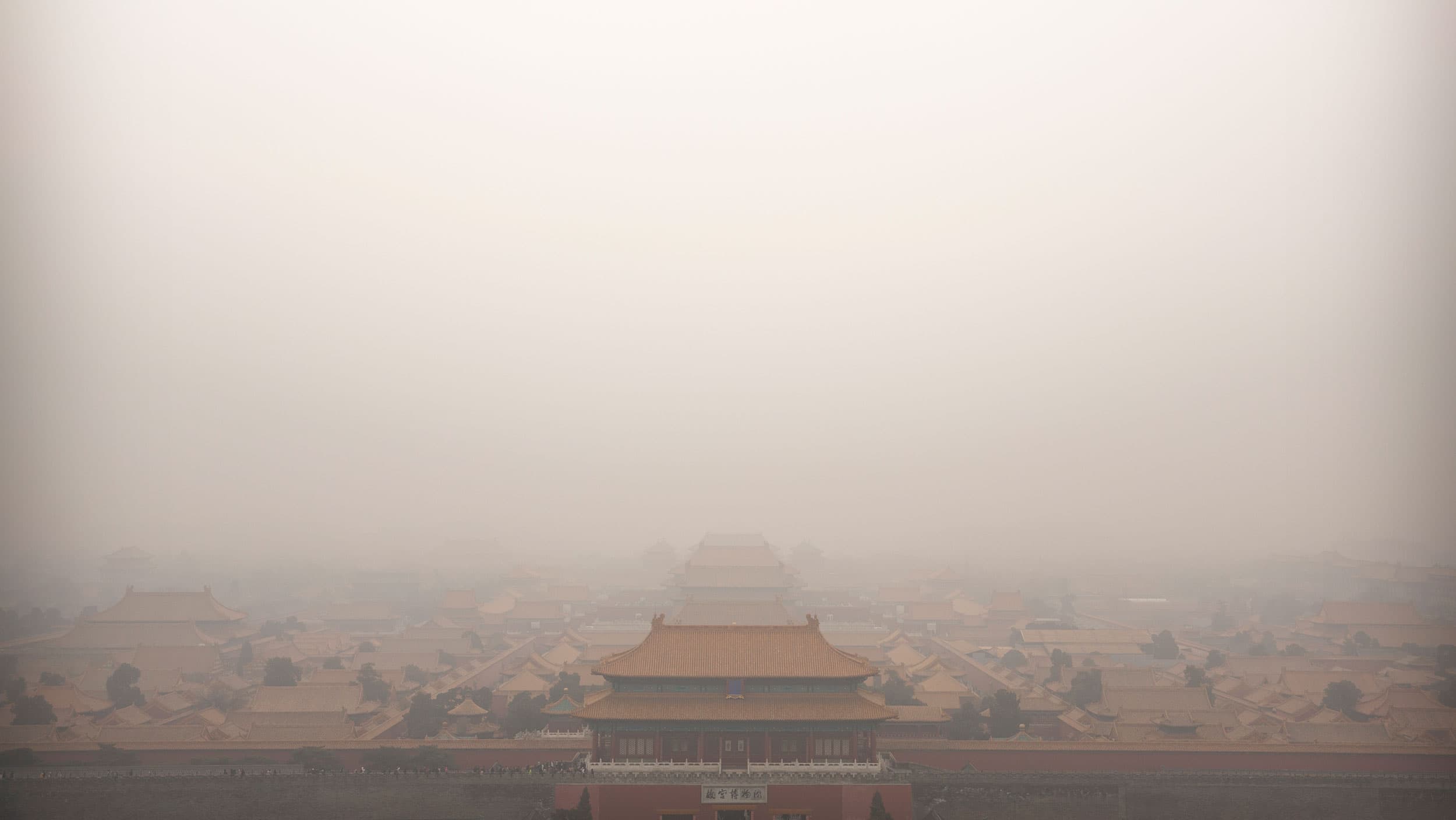 The top of a palace building in China's Forbidden City is barely viewable in a photograph showing a dense amount of smog.