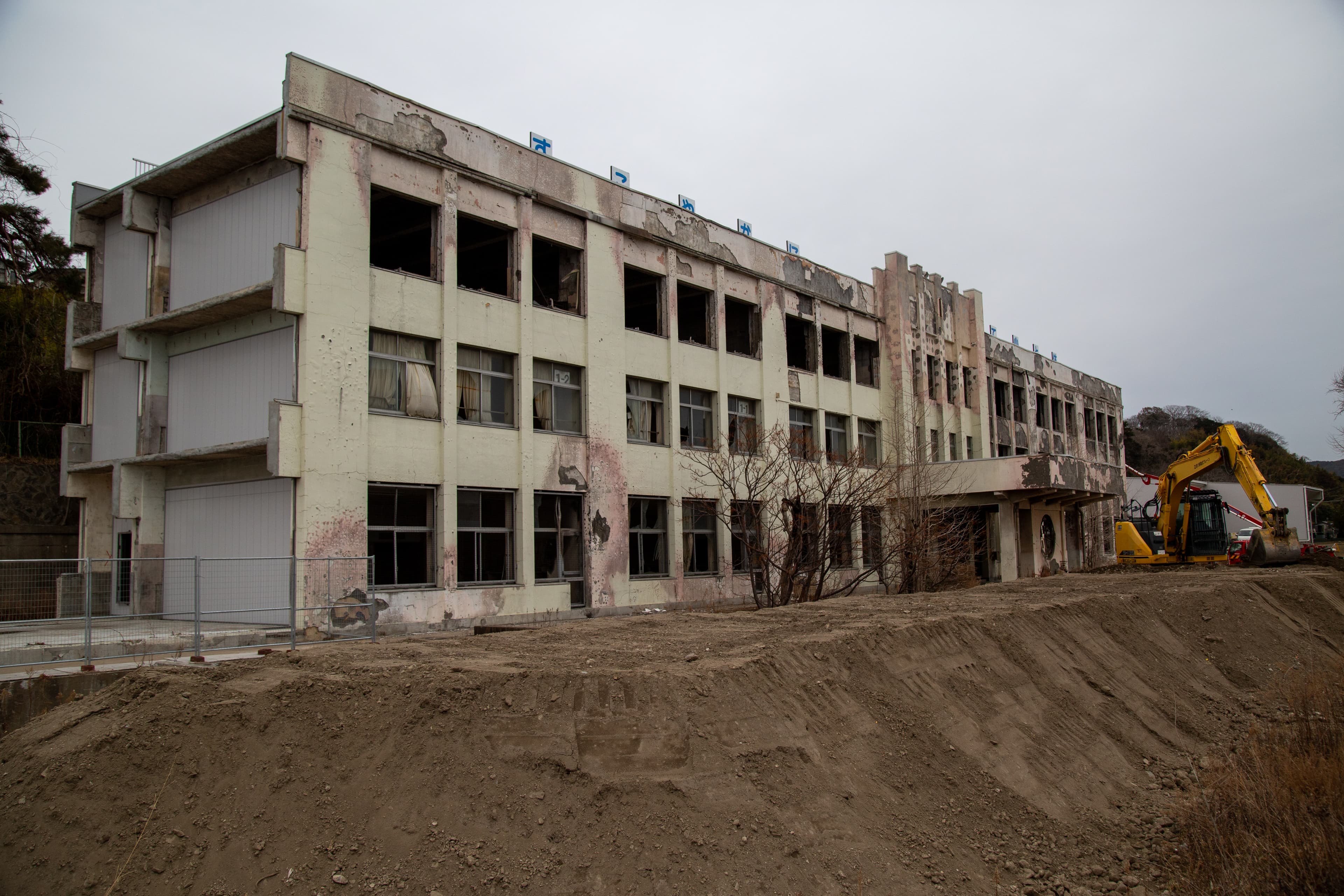 A school is shown burned with a crane at one end.