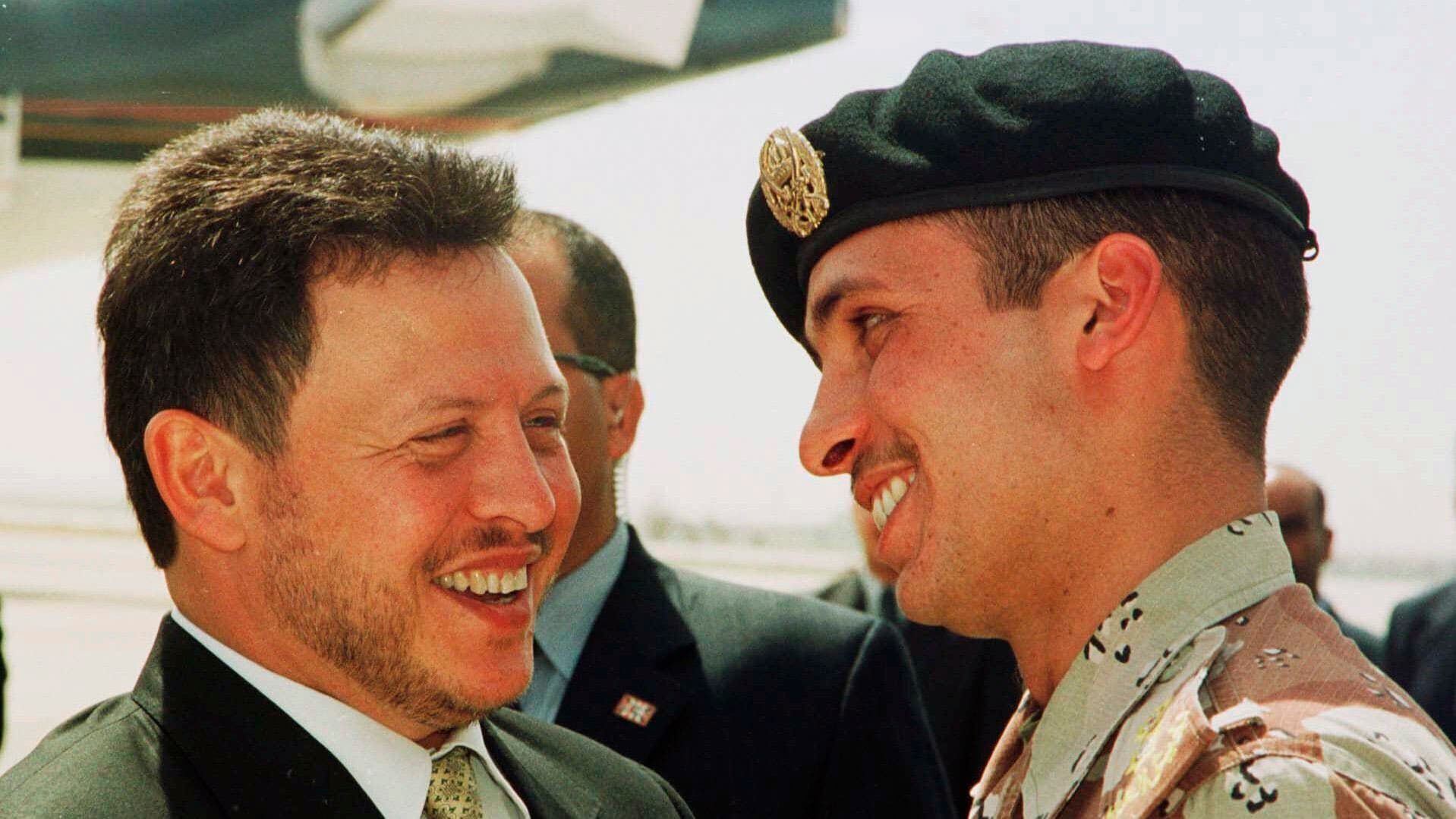 Two people lean in and laugh, talk with each other.