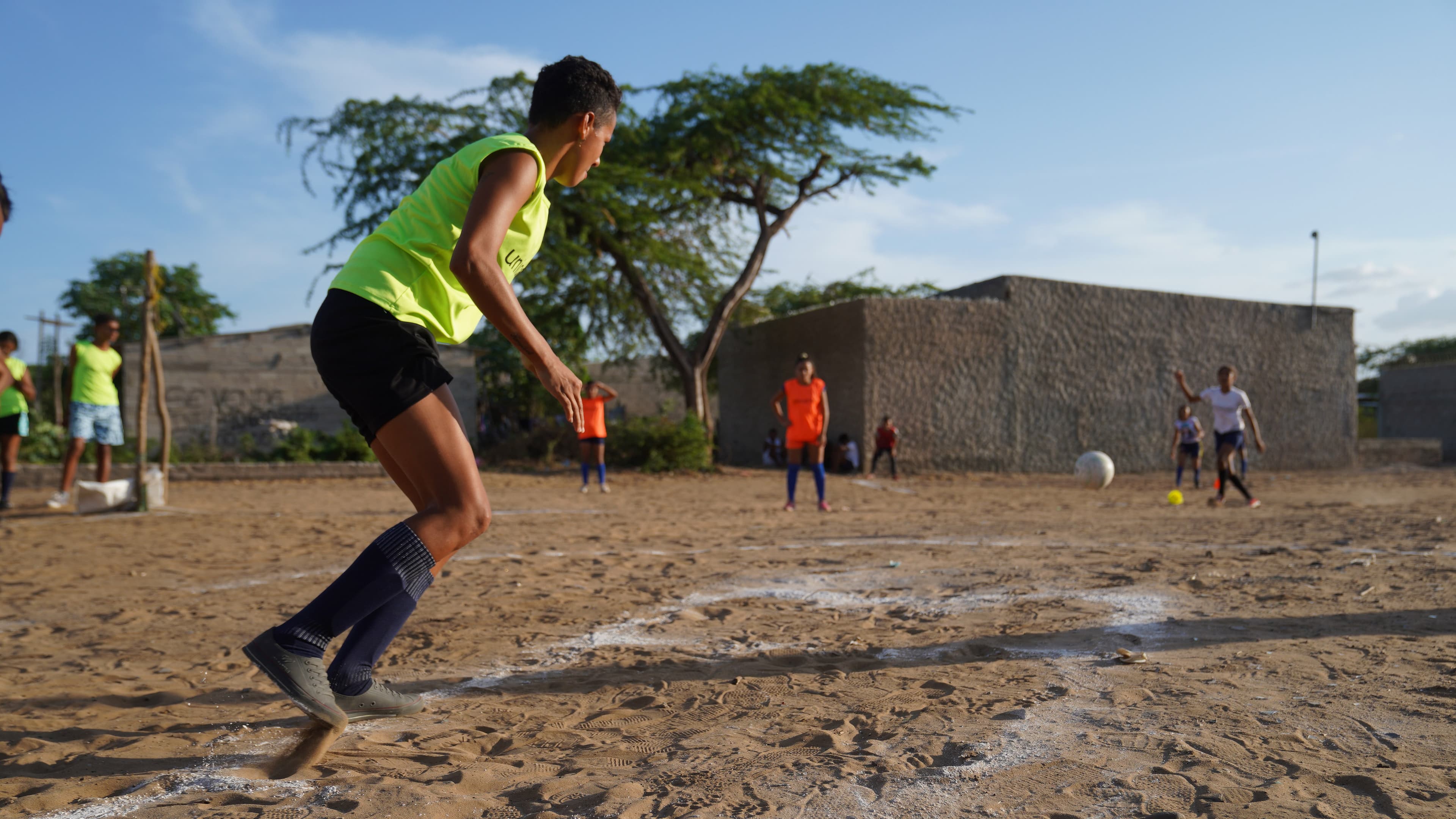 Maria Isabel Parra takes her turn "at bat" during a kickball match in Riohacha, Colombia, March 26, 2021.