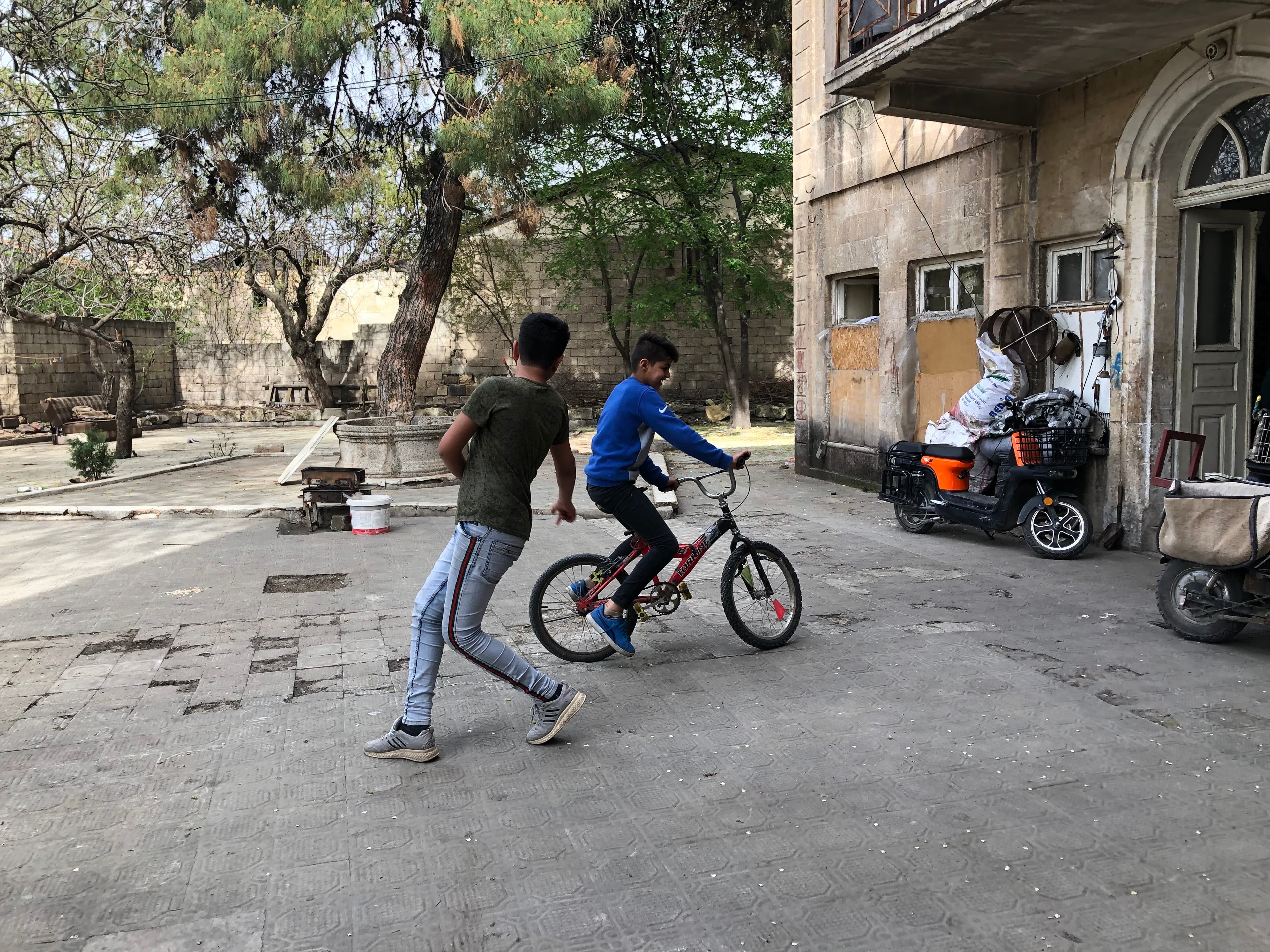 Salim Abdul Ghani has been checking in with Sharifa Riza and her four young sons since the start of the pandemic. They live in an abandoned house tucked away at the end of a narrow alleyway. Riza’s sons went to the Rainbow Center.