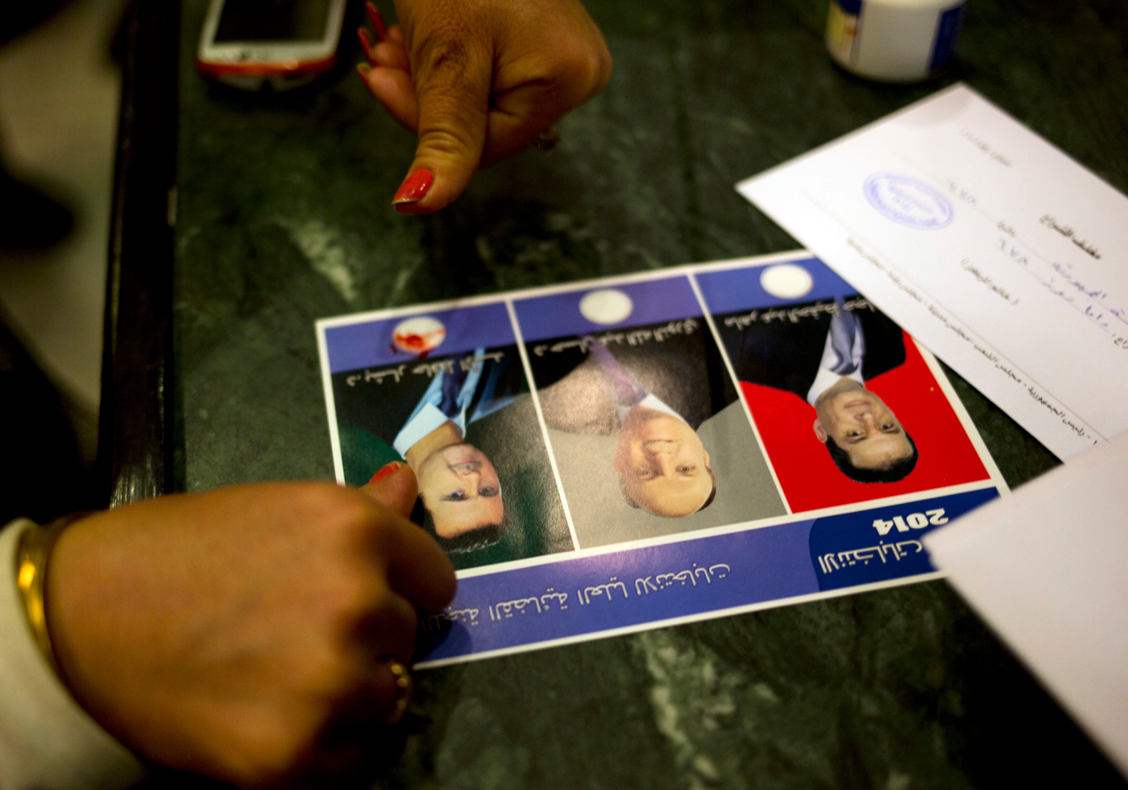 A woman votes for President Bashar al-Assad