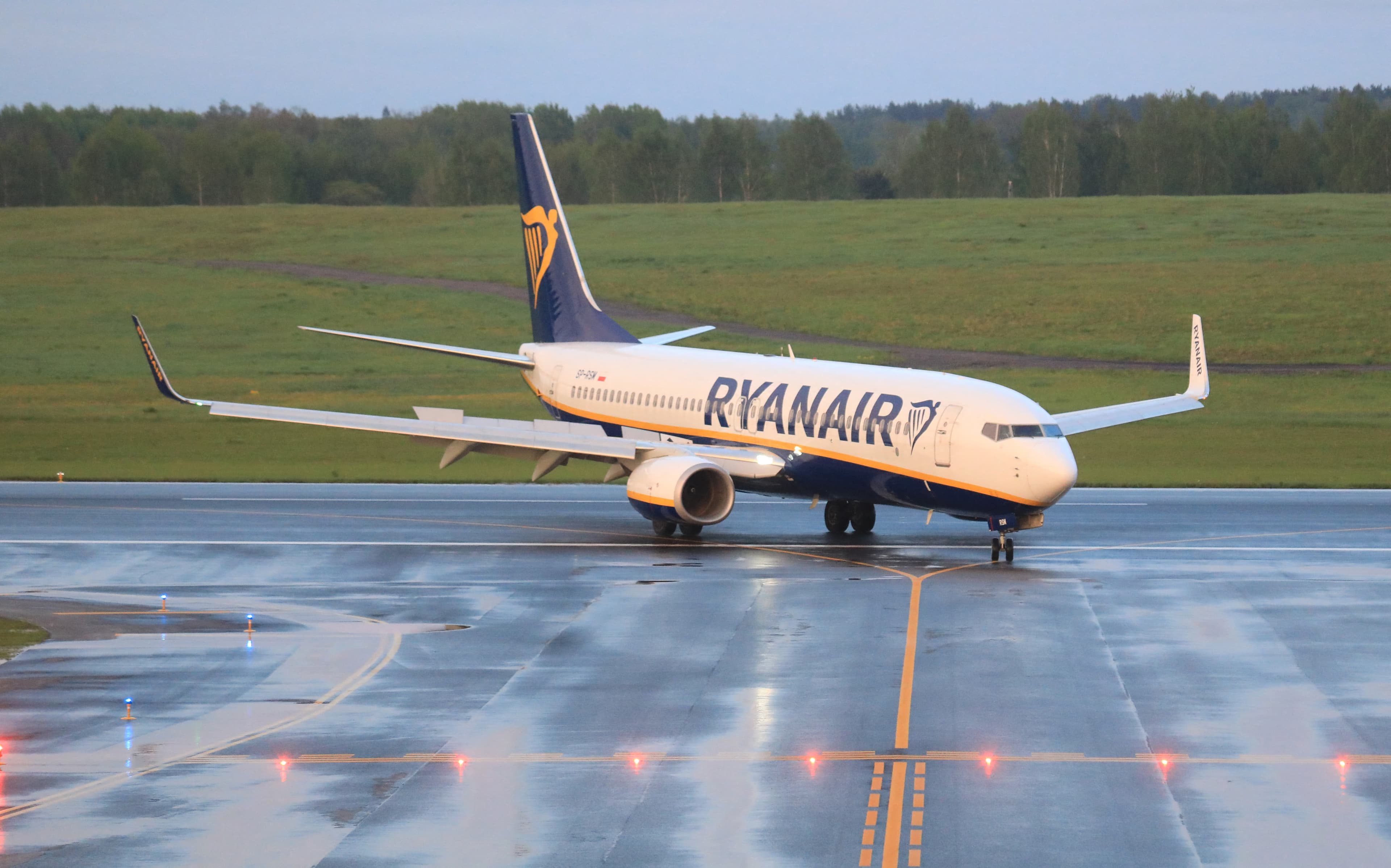 A commercial airplane parked on the airport's runway.