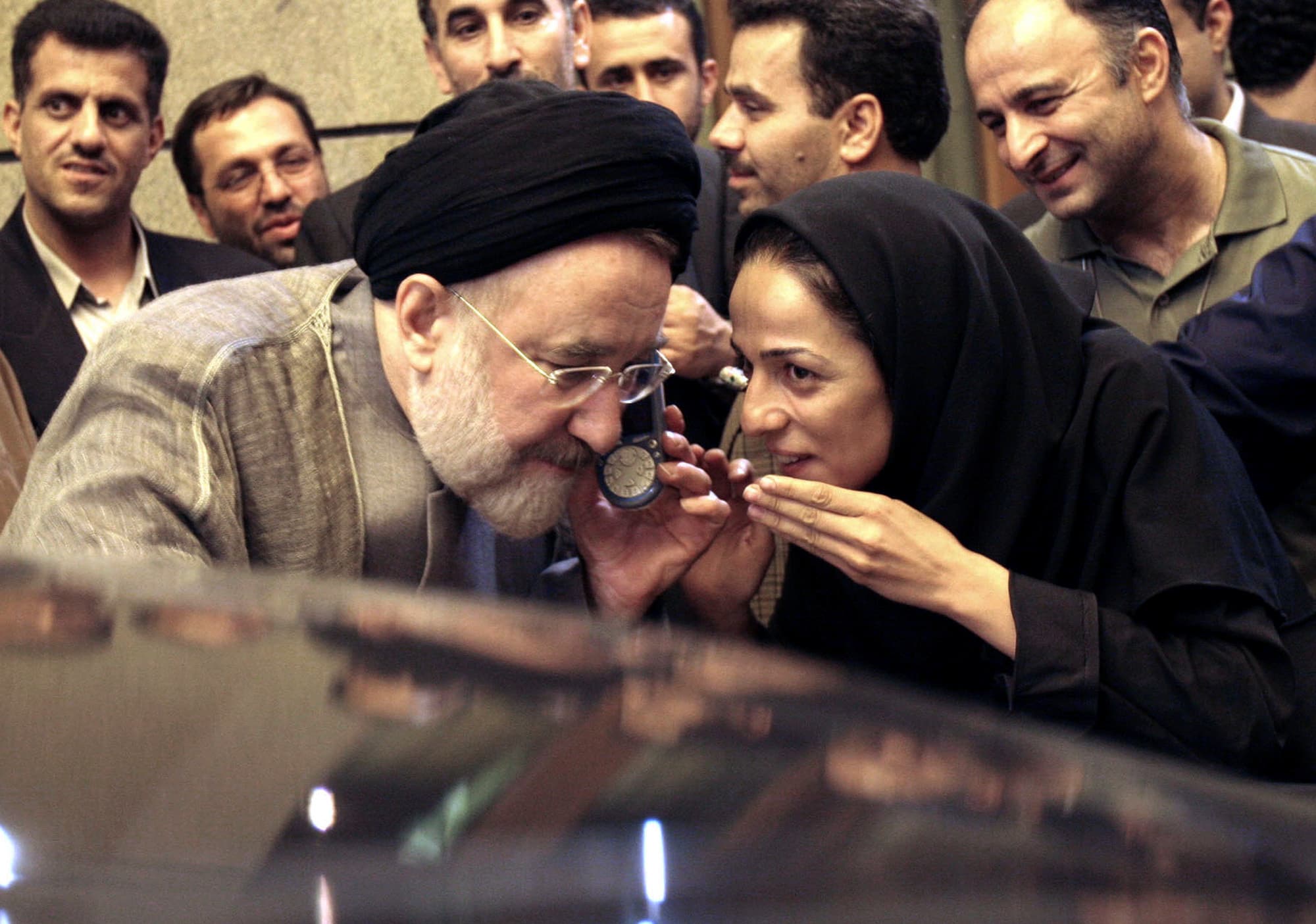 Outgoing reformist Iranian President Mohammad Khatami talks on the phone with the mother of female journalist Masih Alinejad, right, after meeting with journalists in Tehran, Iran, July 13, 2005.