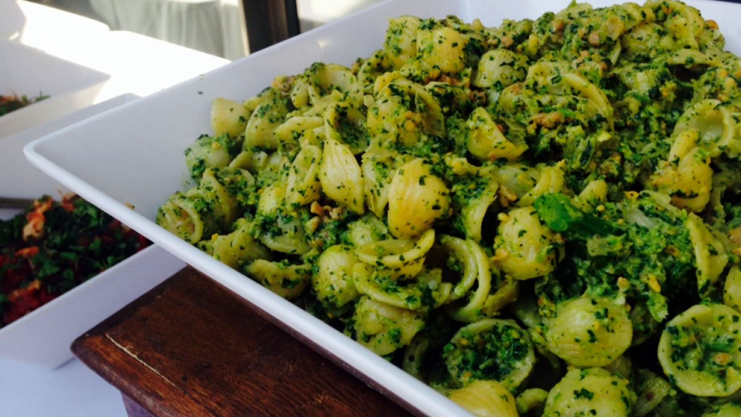 A plate of pasta with green sauces