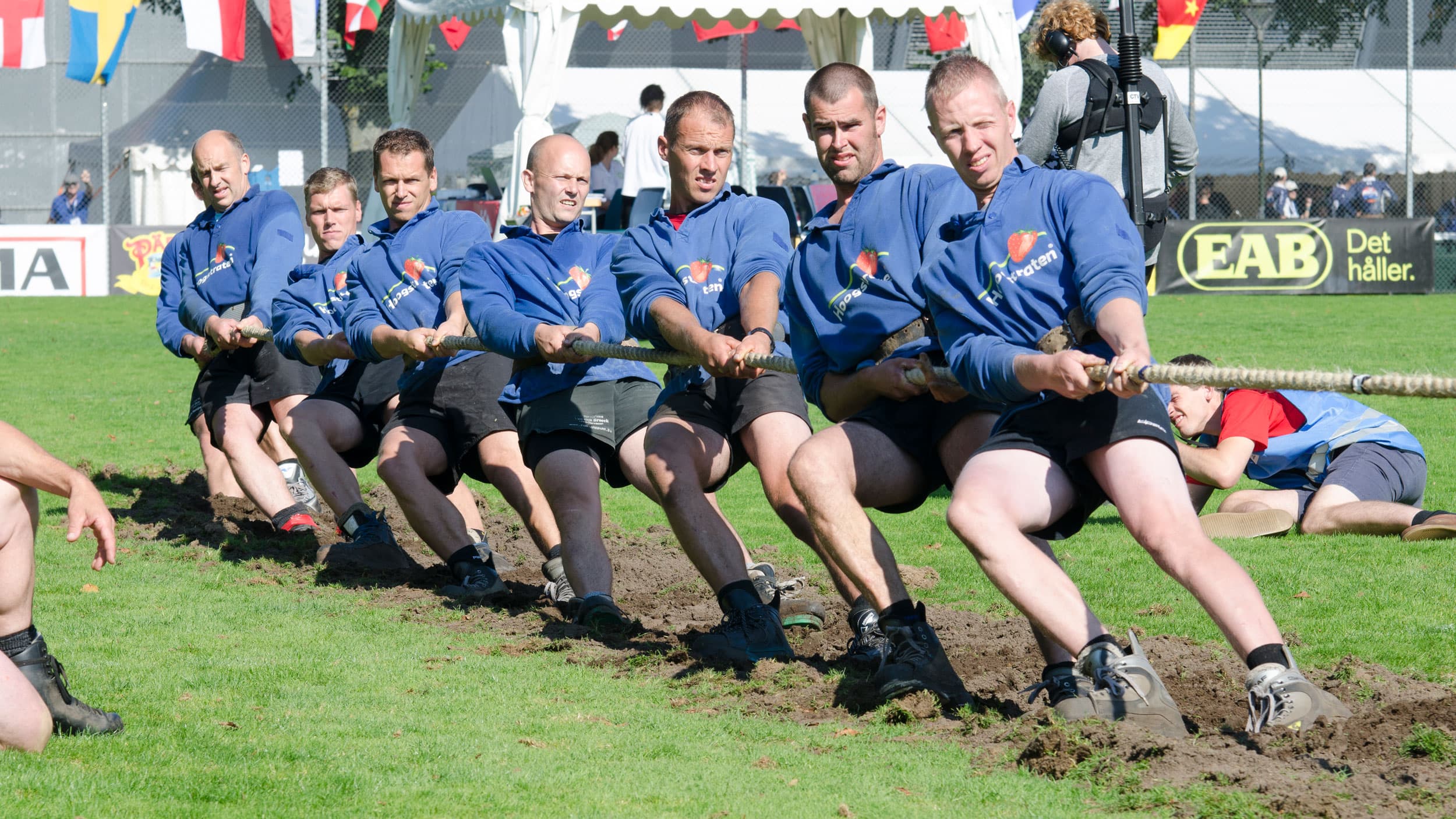 The Belgian men's team wears blue shirts during a tug of war competition.