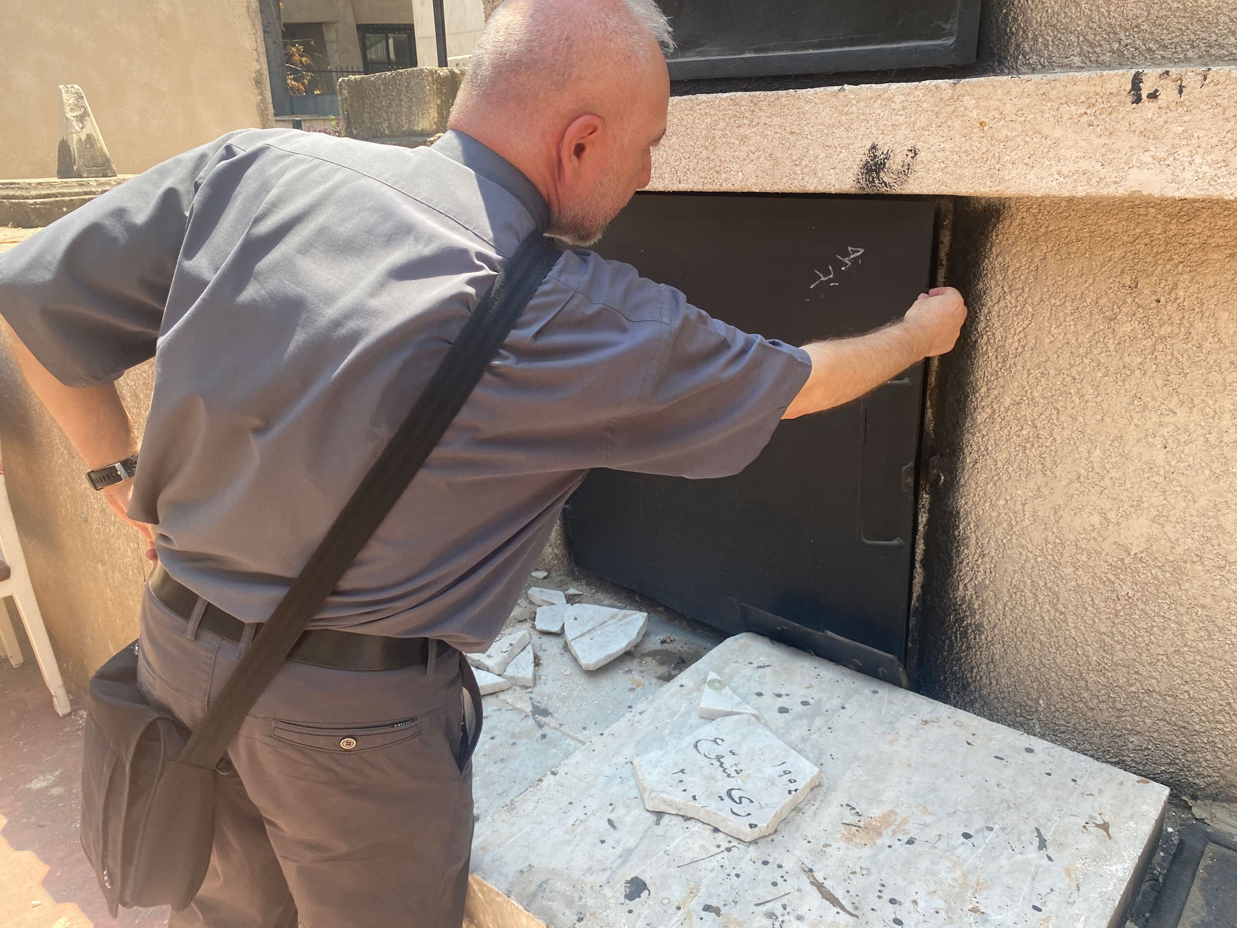 Father Elia had to bury the blast victims next to those open graves. Most of the graves have now been fixed, or at least closed, but tombs and headstones remain cracked.