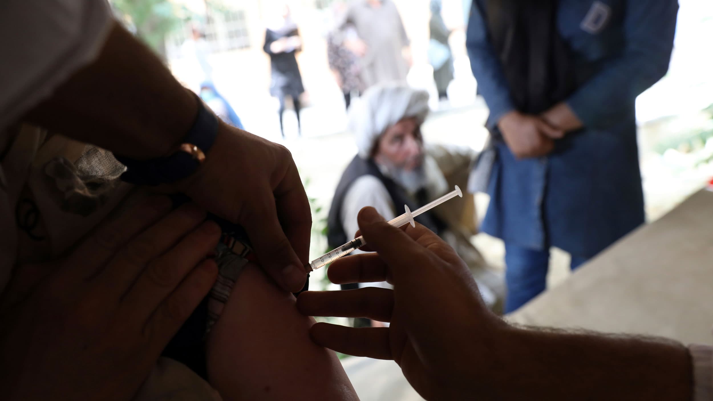 A woman receives the Johnson & Johnson COVID-19 vaccine at a vaccination center in Kabul, Afghanistan, Sunday, July 11, 2021. 