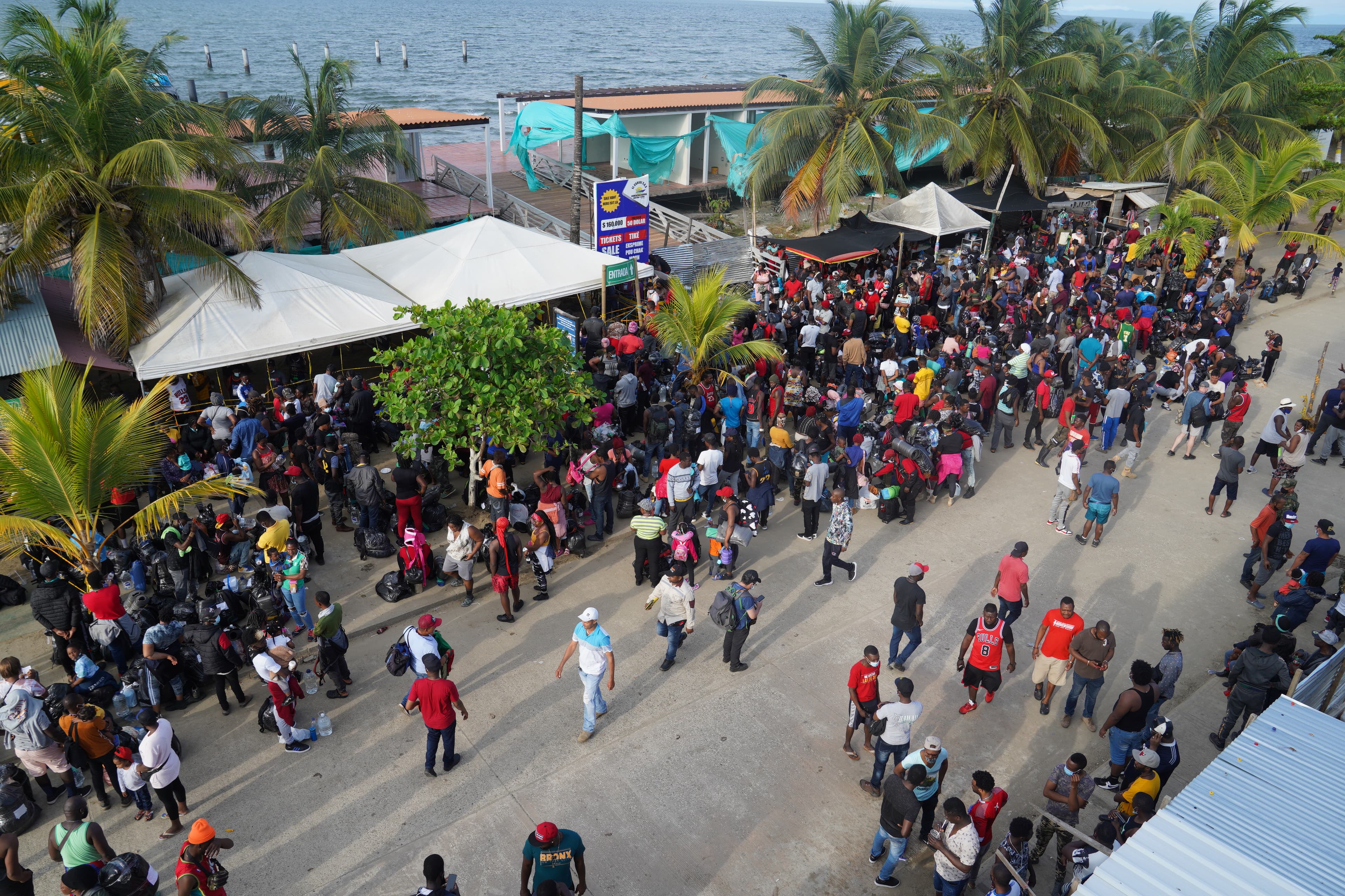 Migrants headed towards Panama wait for boats in the town of Necocli, Colombia
