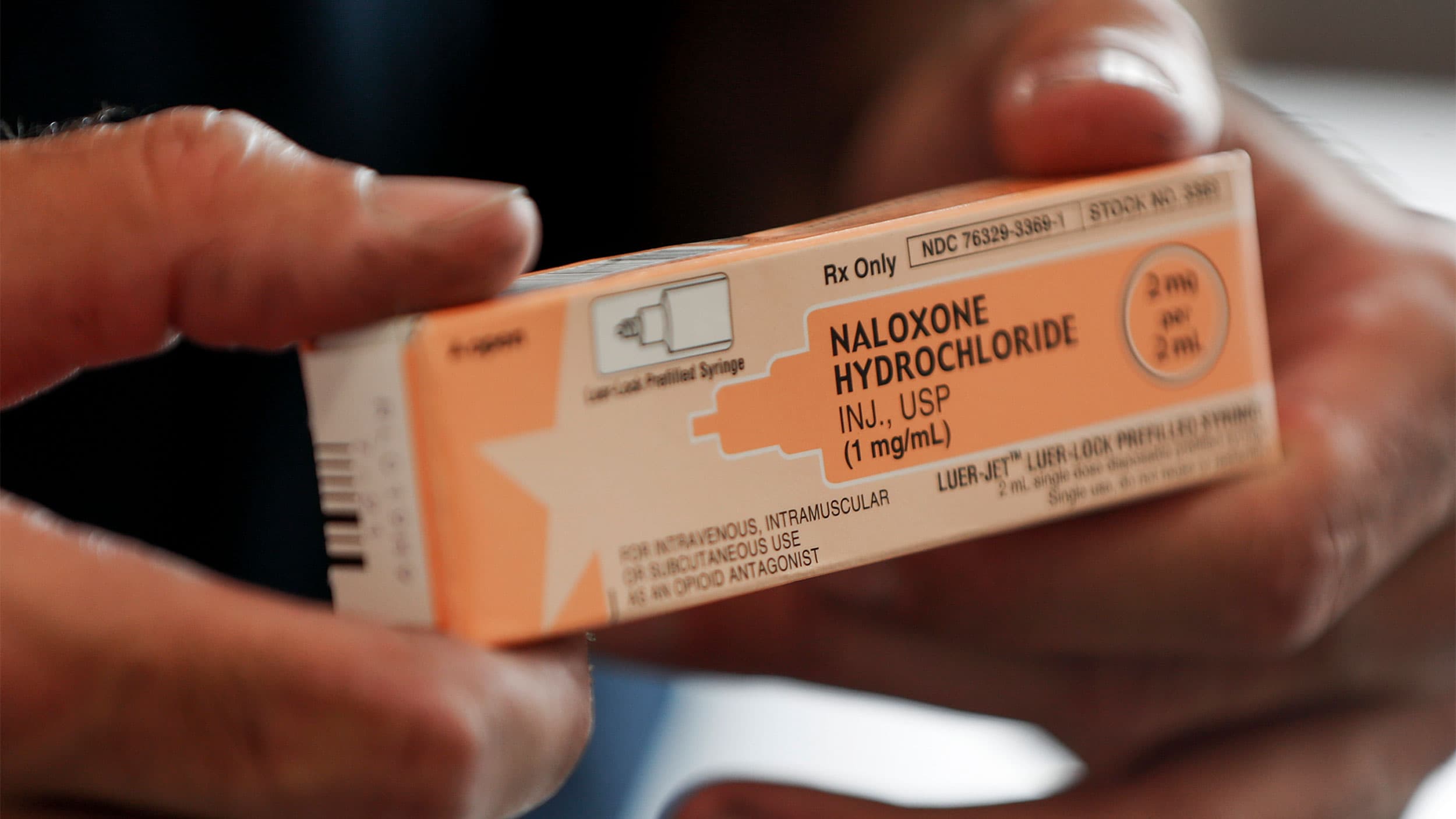 A fire medic holds a box containing naloxone hydrochloride which is carried in all their department's emergency response vehicles, in Akron, Ohio