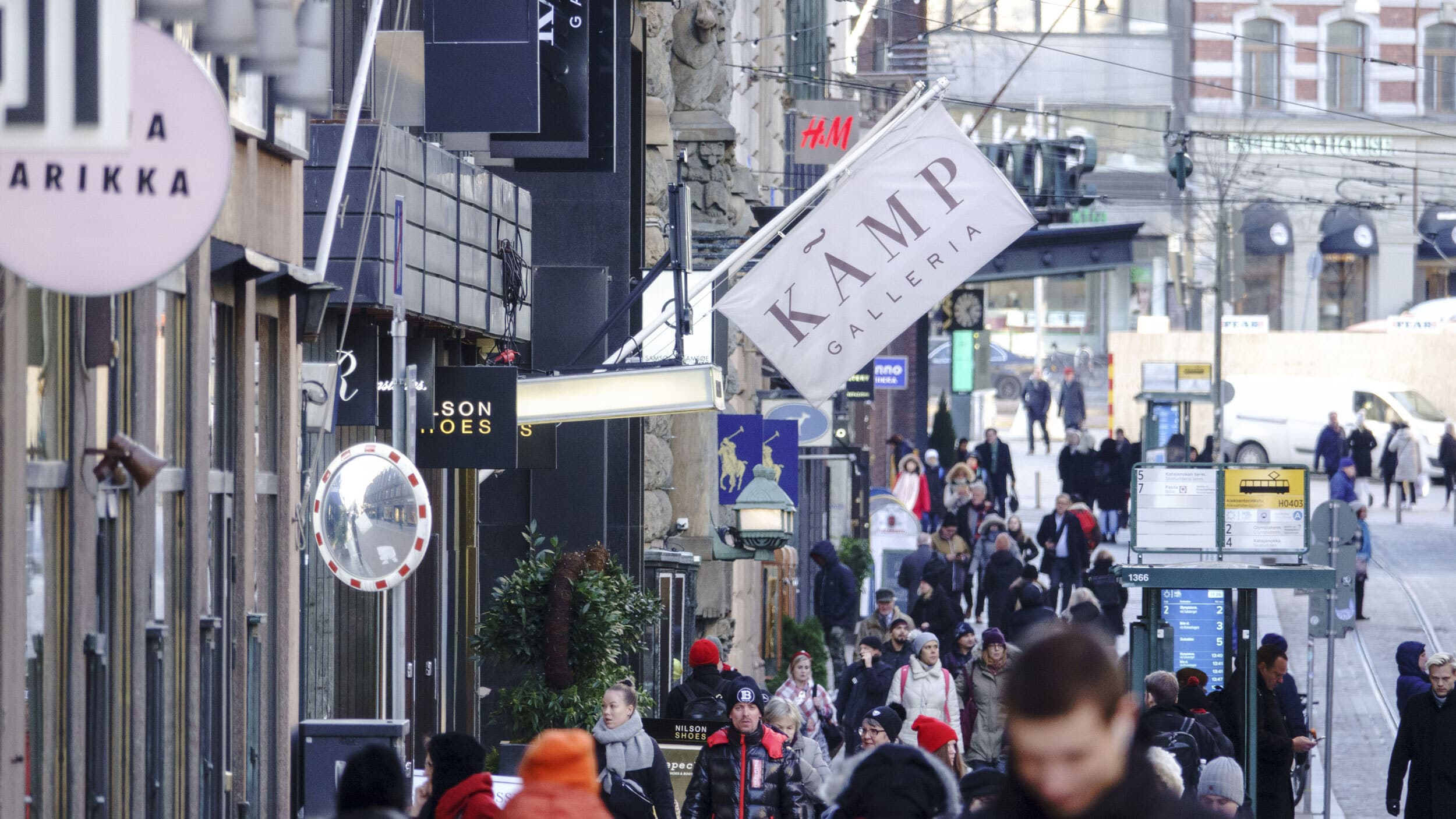 Pedestrians walk along Aleksanterinkatu, the main shopping street, in Helsinki, Finland.