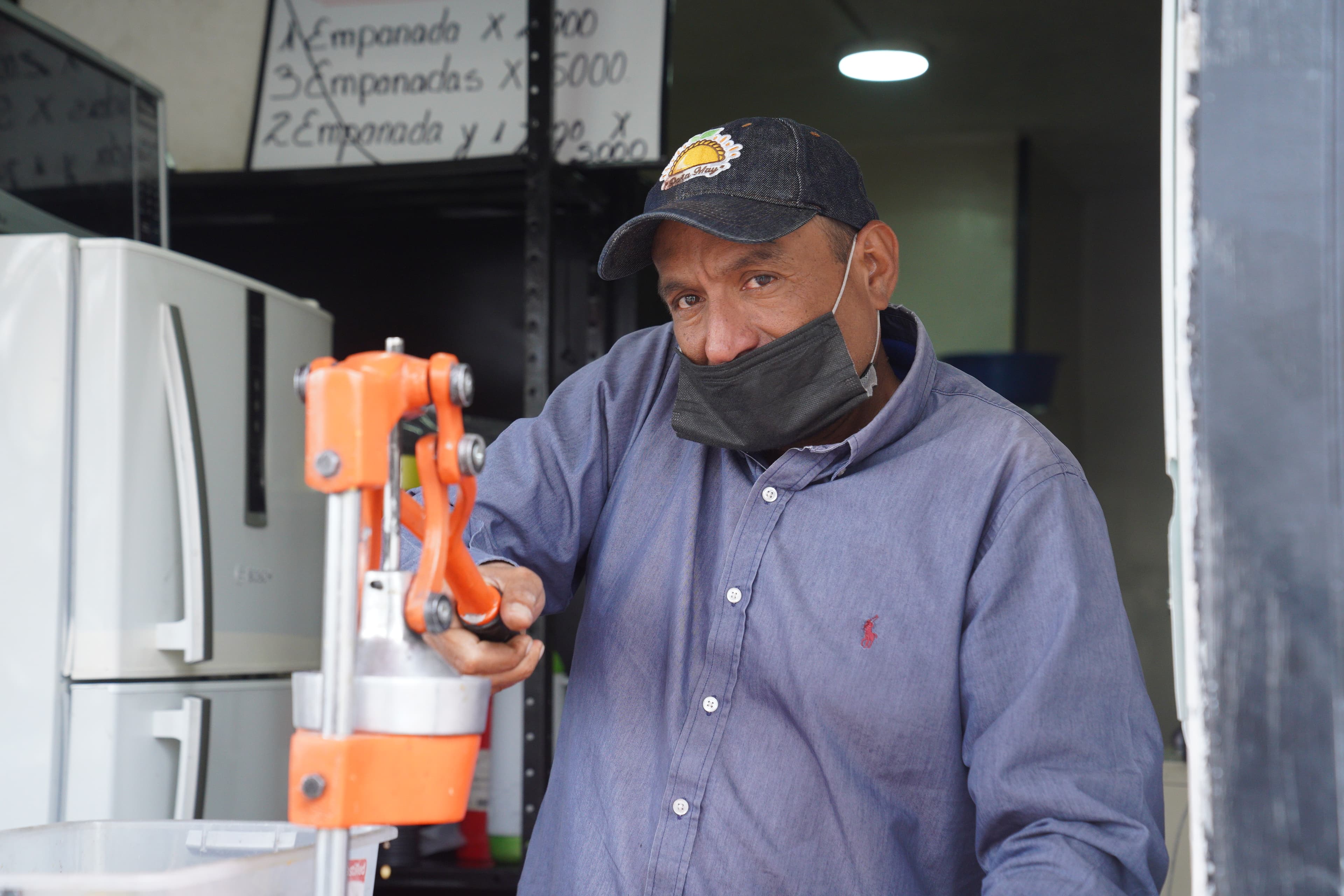 Angel Bruges sells empanadas and orange juice in Bogota. He says that he hasn't gotten vaccinated yet, because filling out his TPS application is complicated.