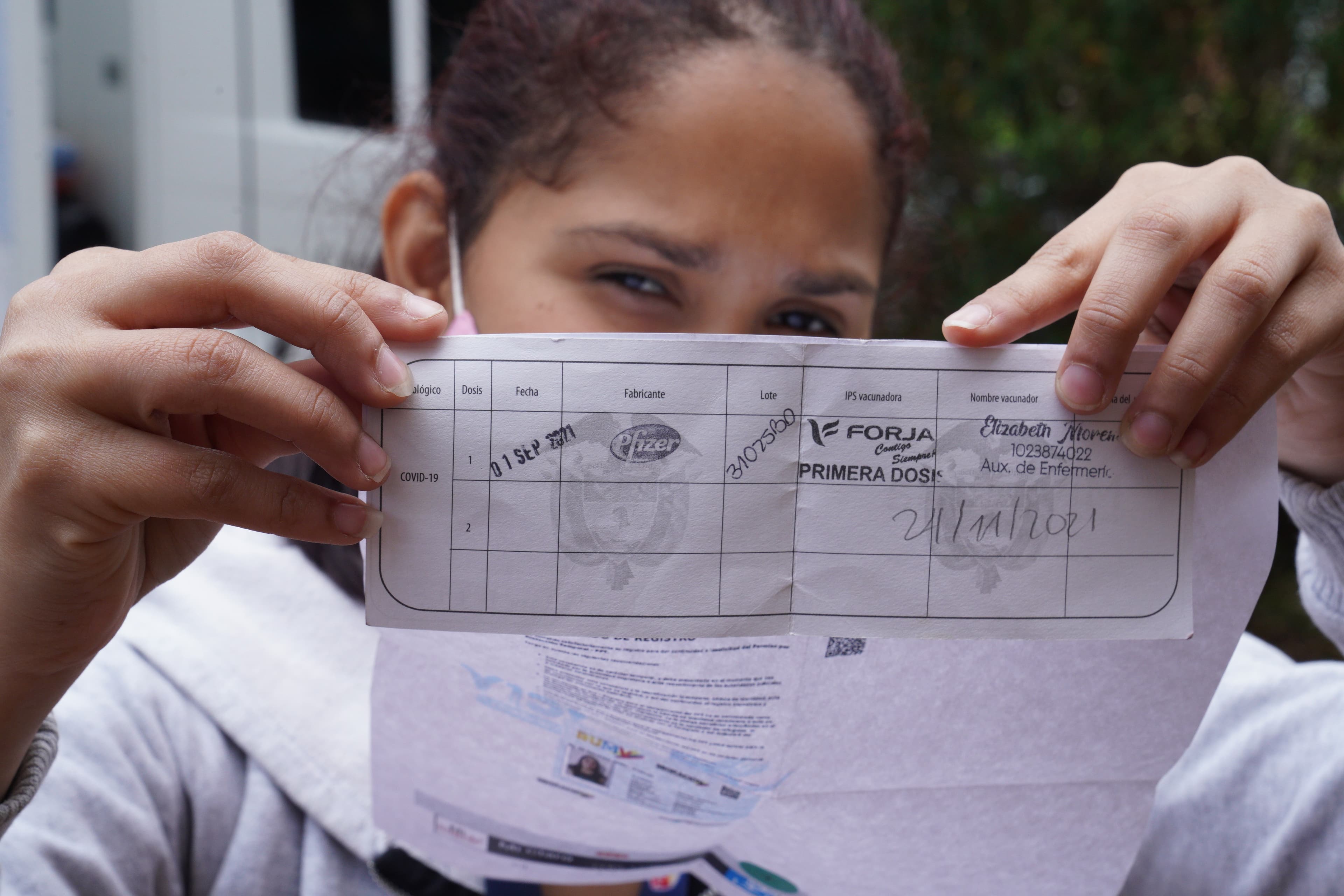 Oriana Fernandez Fernandez got her first dose of the Pfizer Vaccine in Bogota during the first week of September. But only after completing her TPS application and showing a sheet with a QR code that proved it.