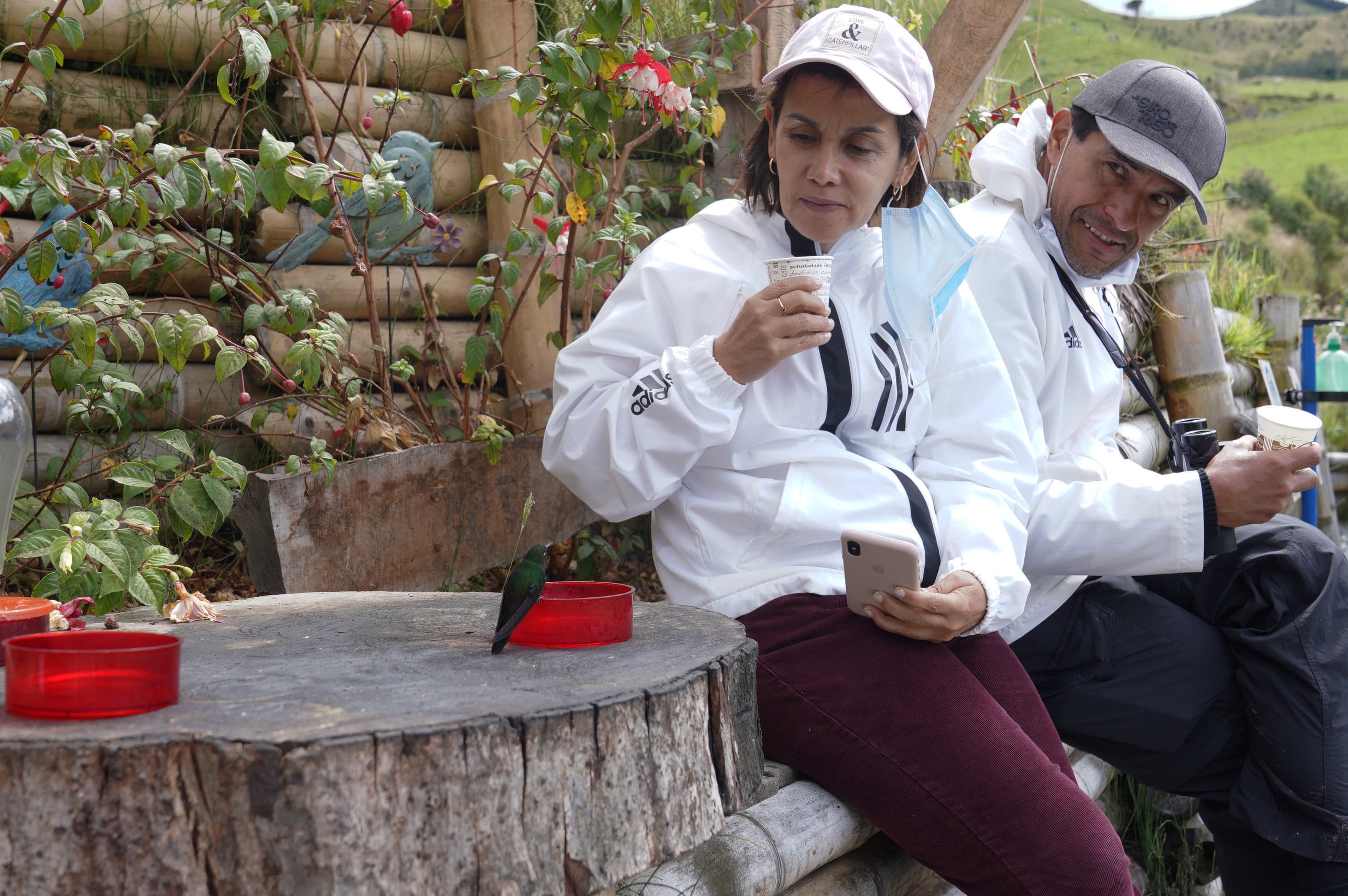 A tourist from Medellin Colombia gets up close with a hummingbird at Hacienda El Bosque.