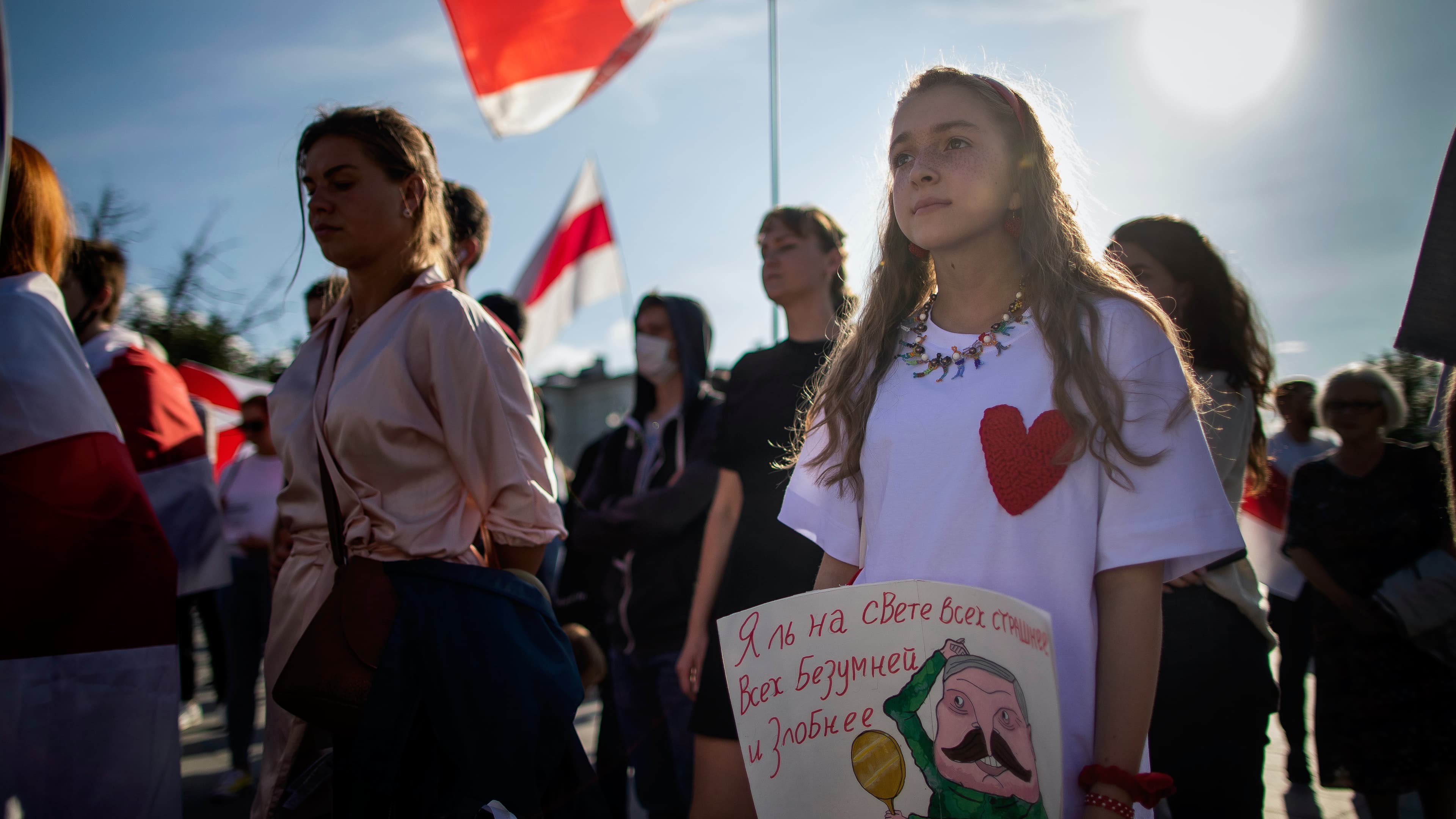 Protesters hold signs