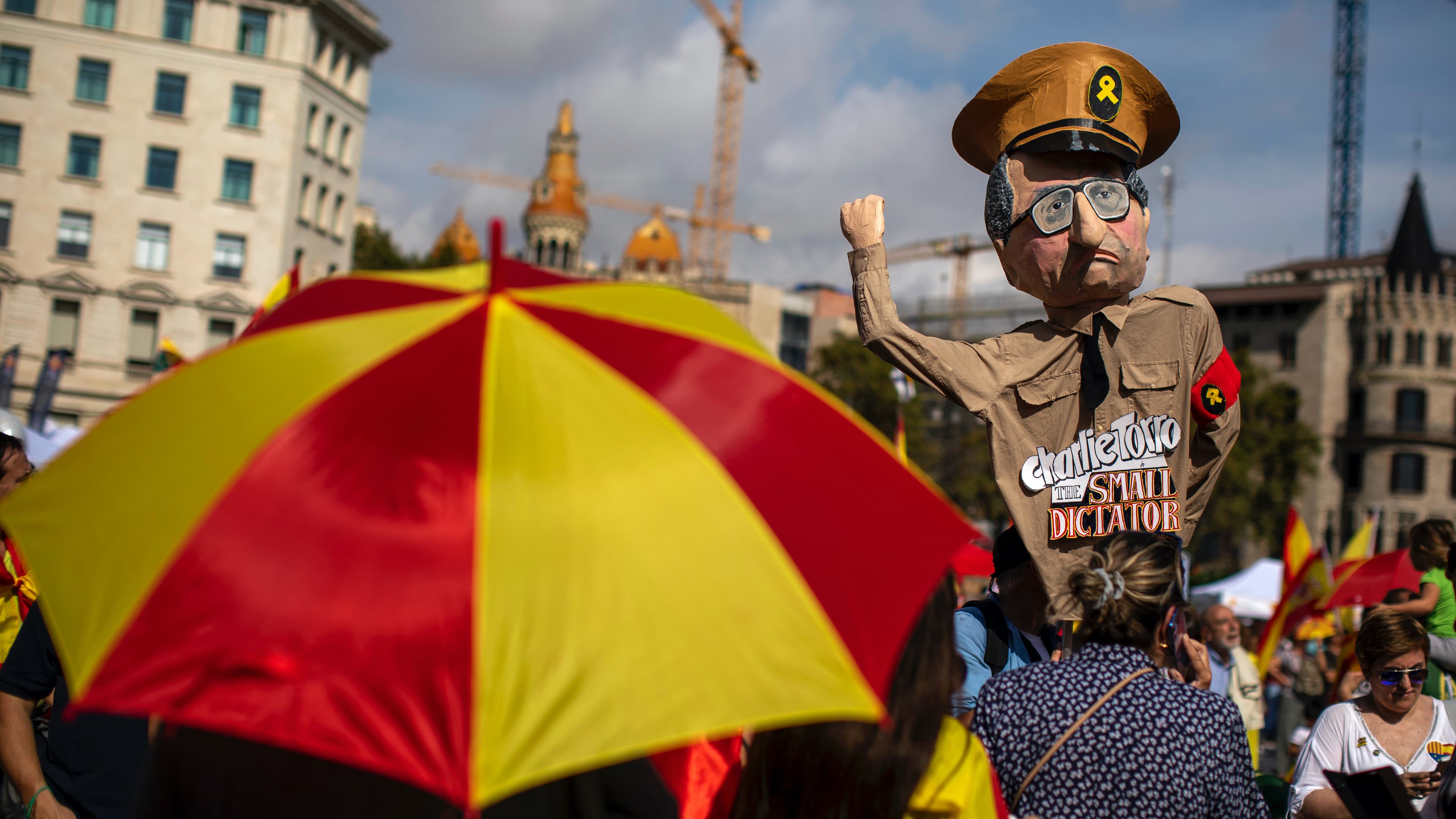 A demonstrator holds a paper doll representing regional Catalan President Quim Torra, as they celebrate a holiday known as "Dia de la Hispanidad" or Spain's National Day in Barcelona, Spain, Oct. 12, 2019. Spain commemorates Christopher Columbus' arrival