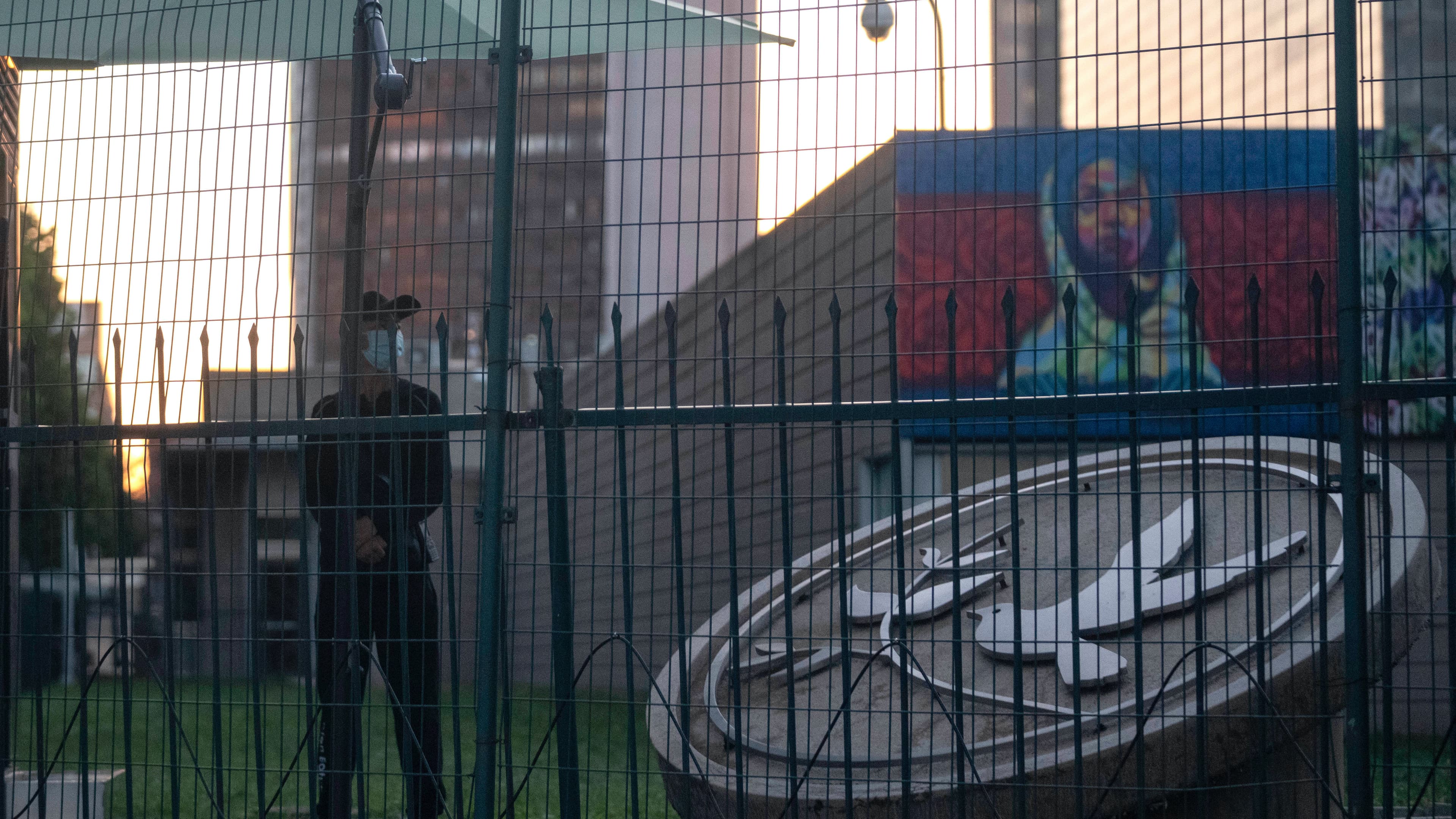 A security guard stands guard behind fences around the US Embassy in Beijing on Sept. 6, 2021.