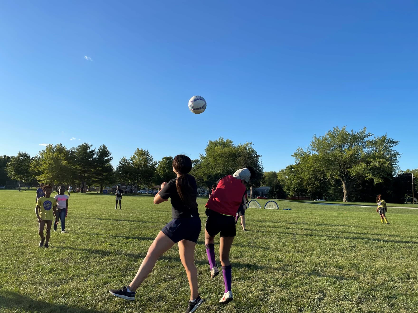 Coach Clare Desio competes with her team for a headshot