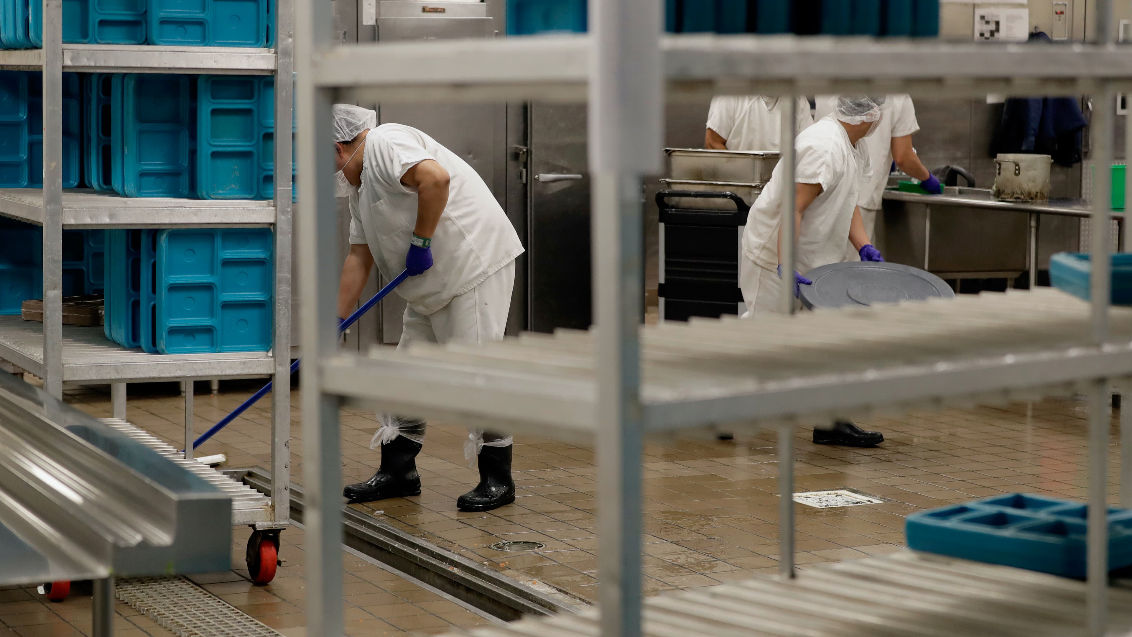 Workers are shown in the kitchen of the US Immigration and Customs Enforcement (ICE) detention facility in Tacoma, Washington, during a media tour, Sept. 10, 2019.