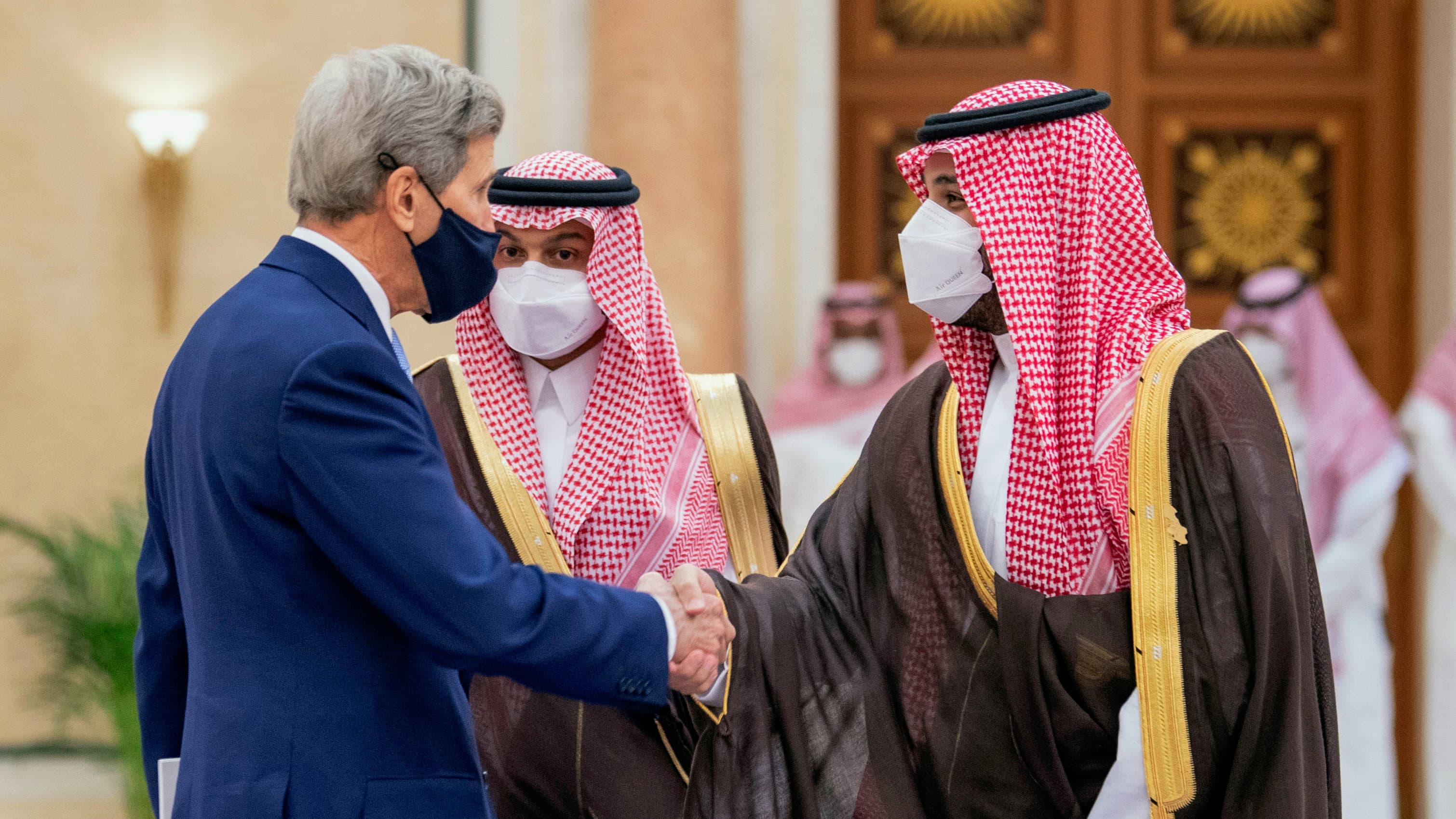 In this photo provided by the Saudi Royal Palace, Saudi Crown Prince Mohammed bin Salman, right, greets US Special Presidential Envoy for Climate John Kerry during the Green Initiative Summit in Riyadh, Saudi Arabia, Oct. 25, 2021.