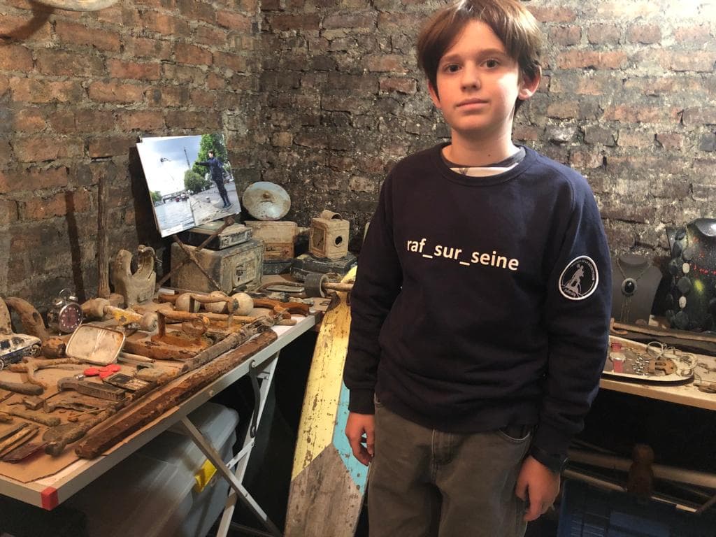 Raphael is pictured alongside some of the artifacts he has procured from the Seine in Paris.
