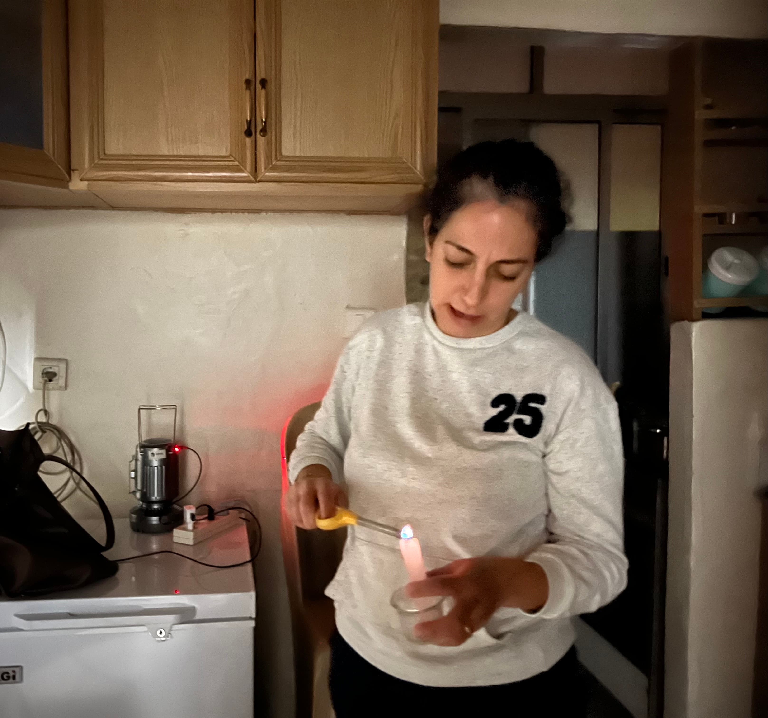 Diala Attieh Younes in Beirut has become much more reliant on candles for light as her family's power bills have skyrocketed.