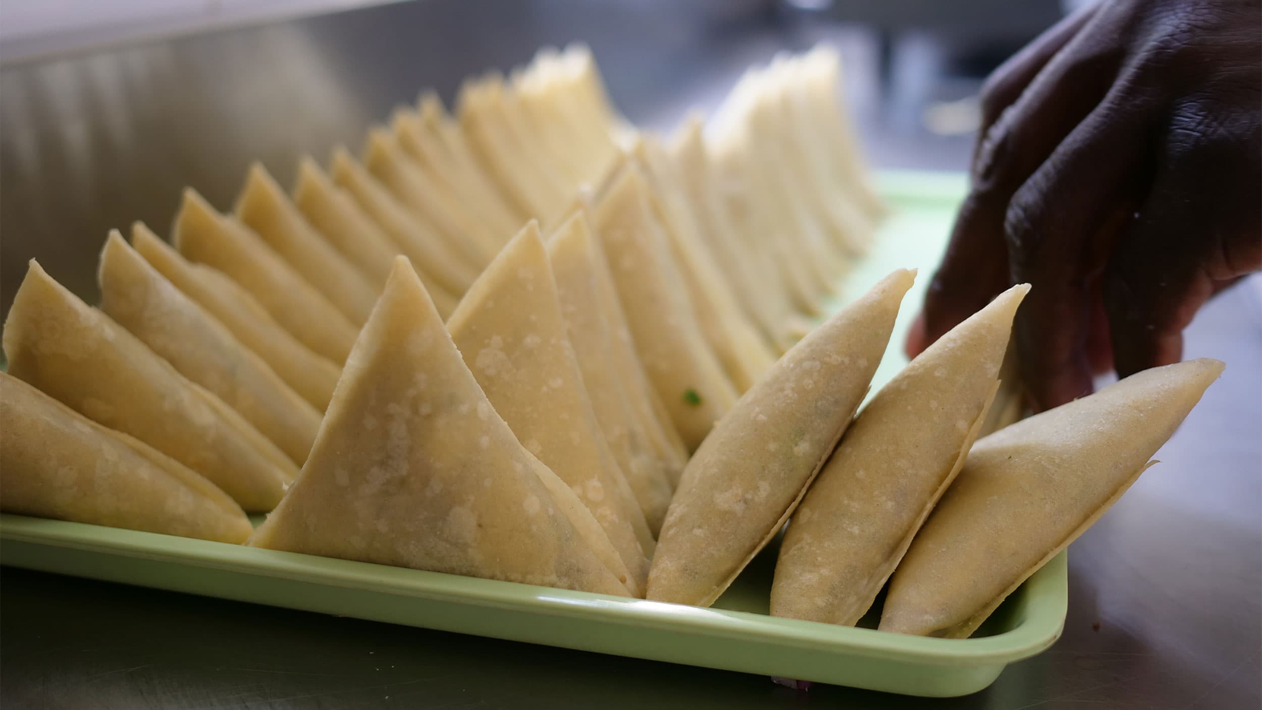 Rows of fresh Wau Eats samosas waiting to be packed and delivered to eager customers, Nairobi, Kenya