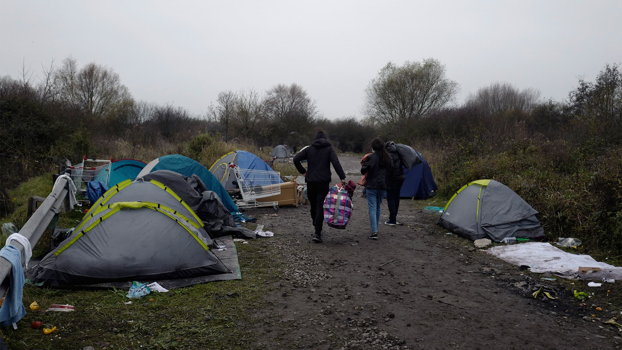 A makeshift camp for migrants is set up along the river in Loon Plage, near Grande-Synthe, northern France