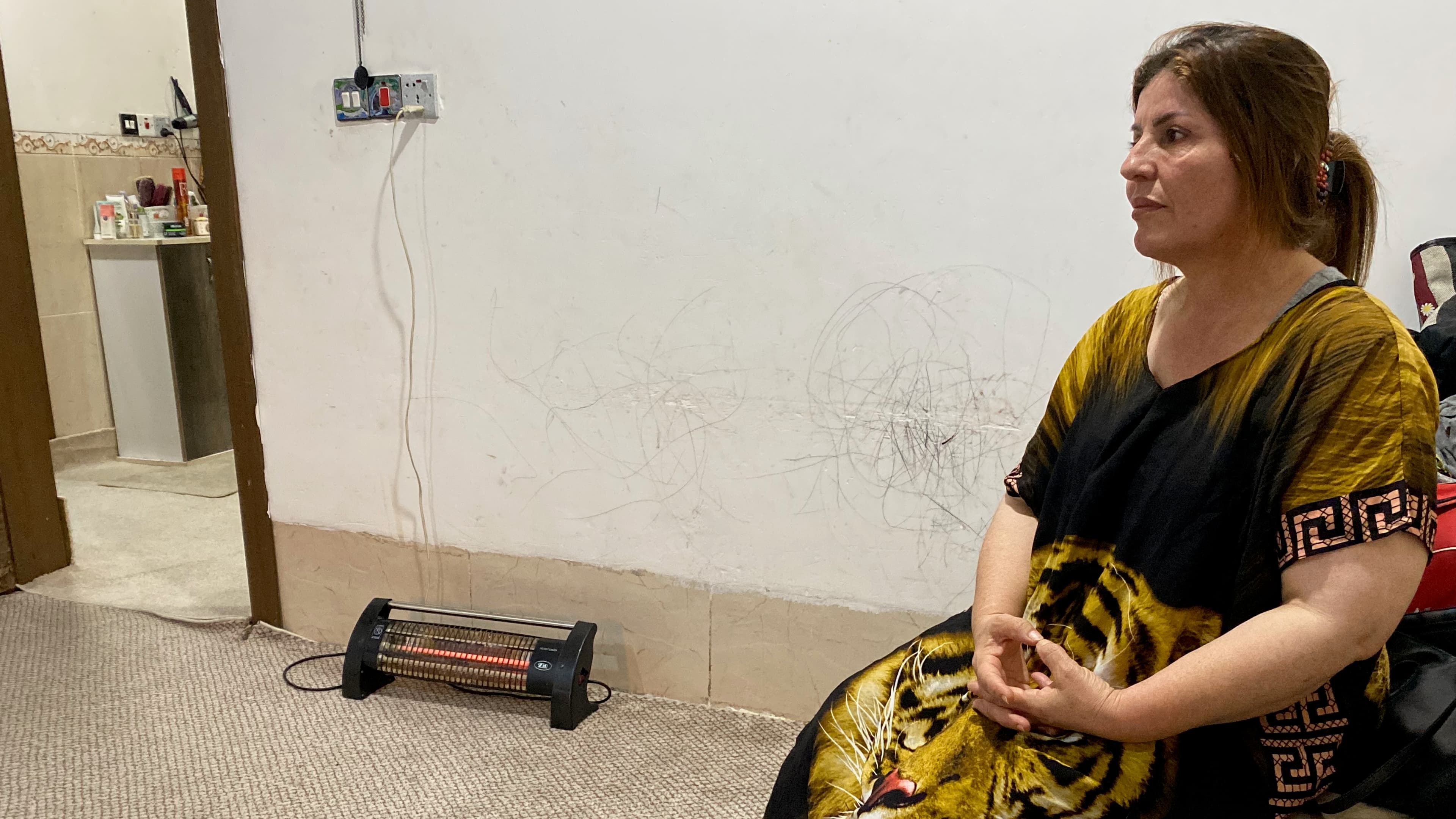 Yadgar Hussein recounts her perilous journey through Eastern Europe in her living room in Erbil after being deported from Poland, Nov. 24, 2021.