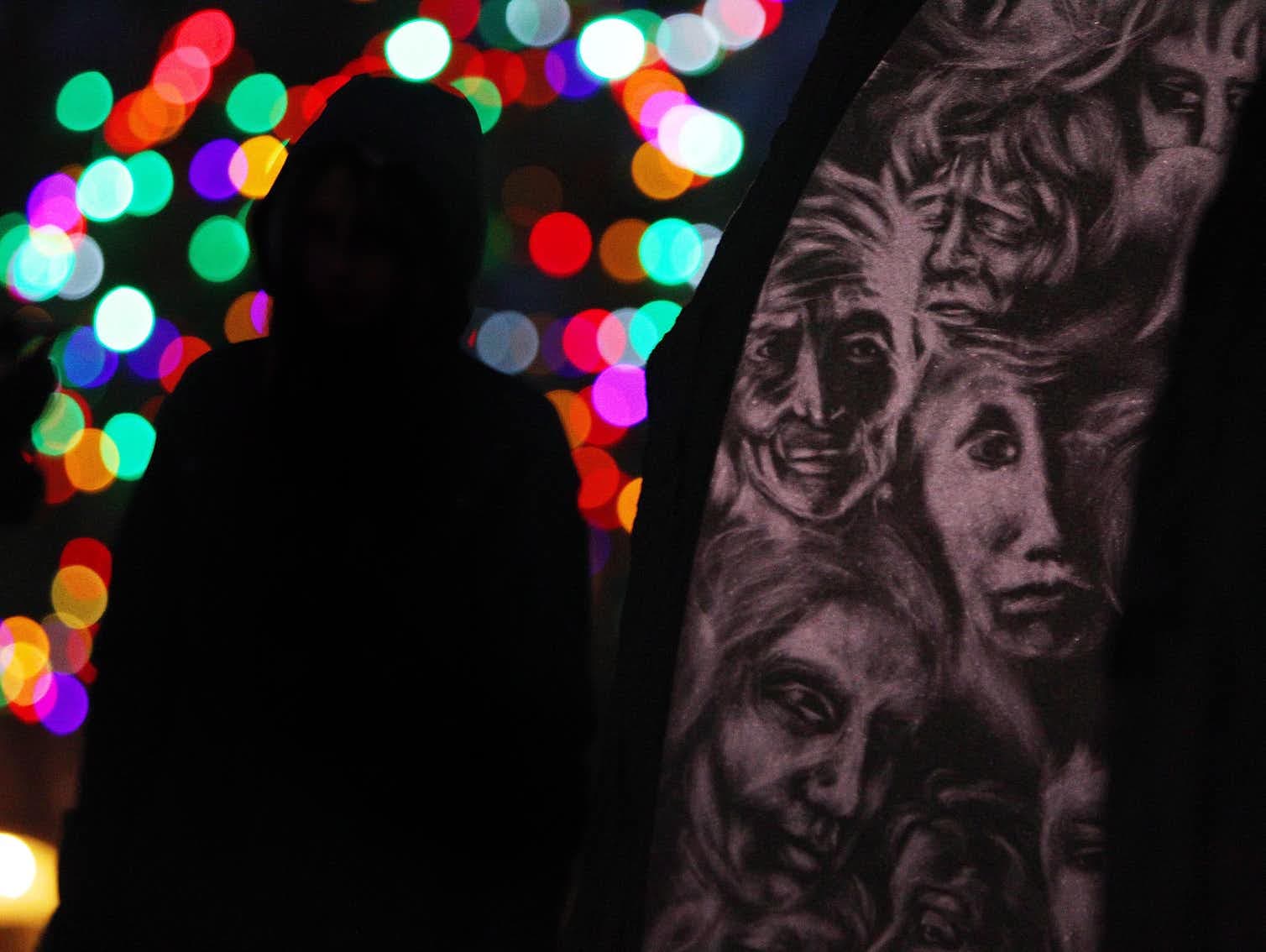 A woman stands next to the Women’s Monument in London, Ont., as people gather to mark the 25th anniversary of the ÉcolePolytechnique massacre in 2014