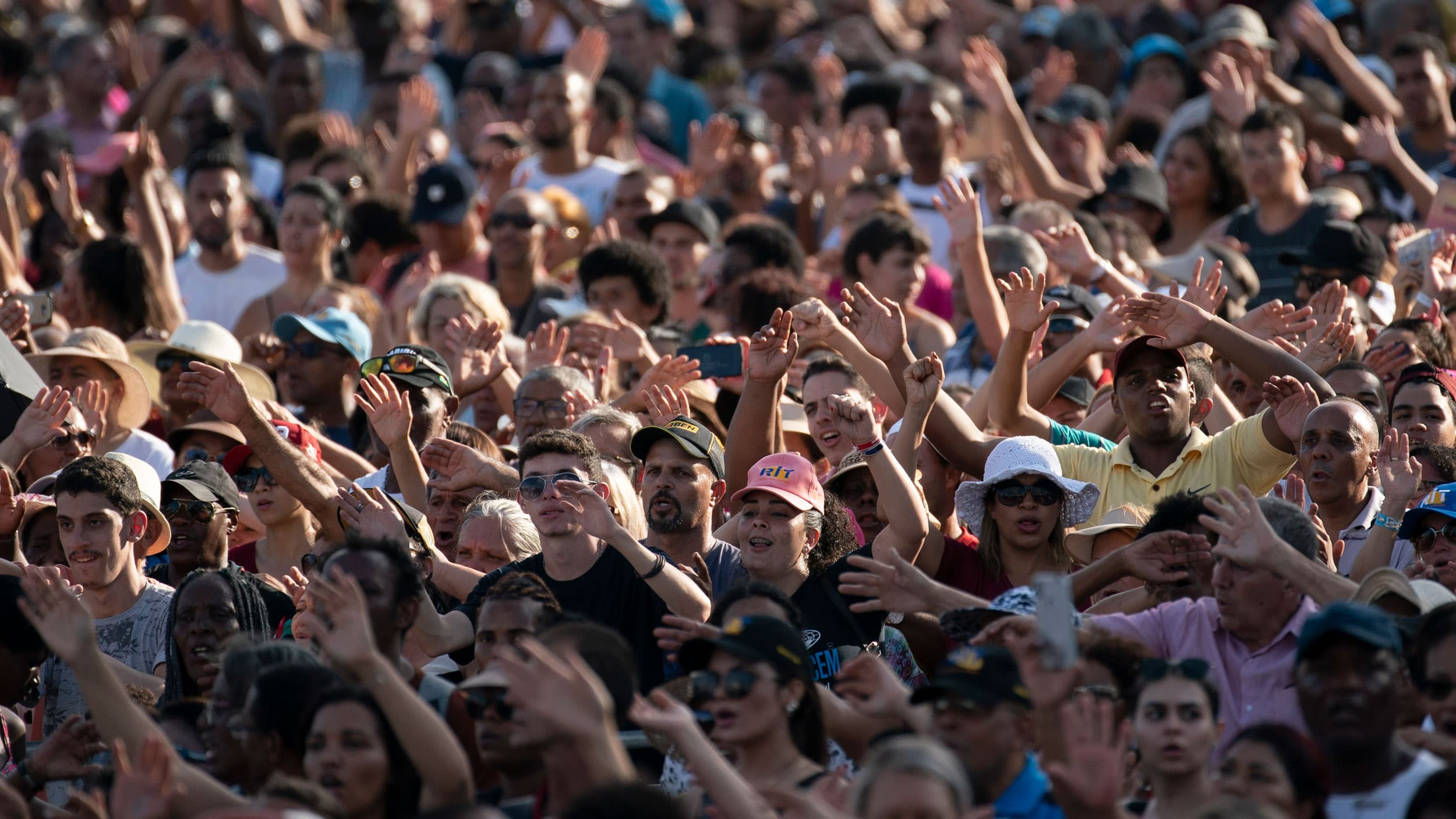 Christians raise their hands in praise during an International Grace of God Church event led by televangelist R.R. Soares, with President Jair Bolsonaro in attendance, at Botafogo beach in Rio de Janeiro, Brazil, Saturday, Feb. 15, 2020. 