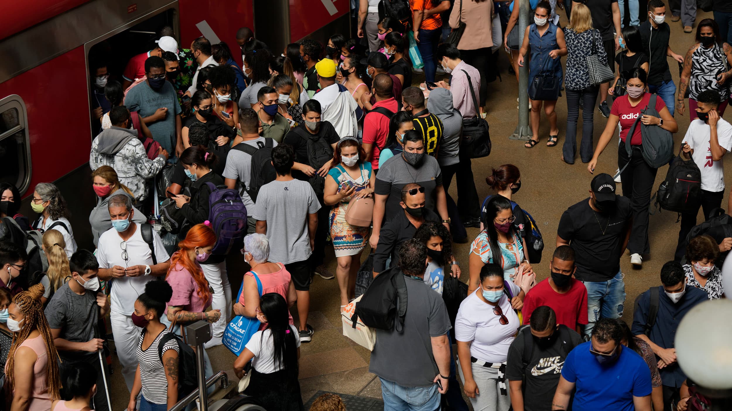 Commuters wear protective face masks as they walk through a subway station, in São Paulo, Brazil, Wednesday, Dec. 1, 2021, amid the COVID-19 pandemic. Brazil joined the widening circle of countries to report cases of the omicron variant. 