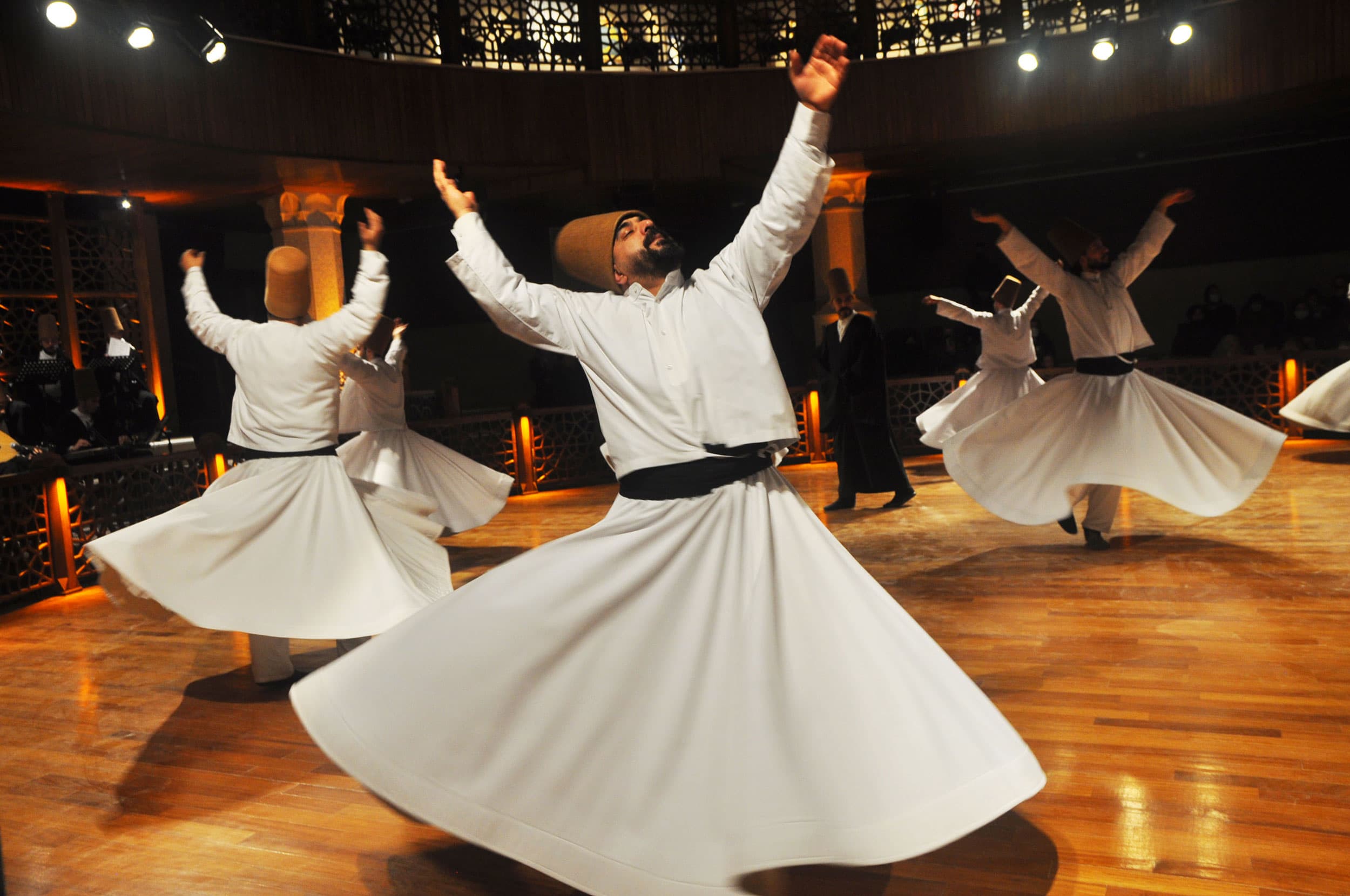 A semazen leans his head back while turning during a sema ritual at the Irfan Civilization Research and Culture Center in Konya, Turkey.