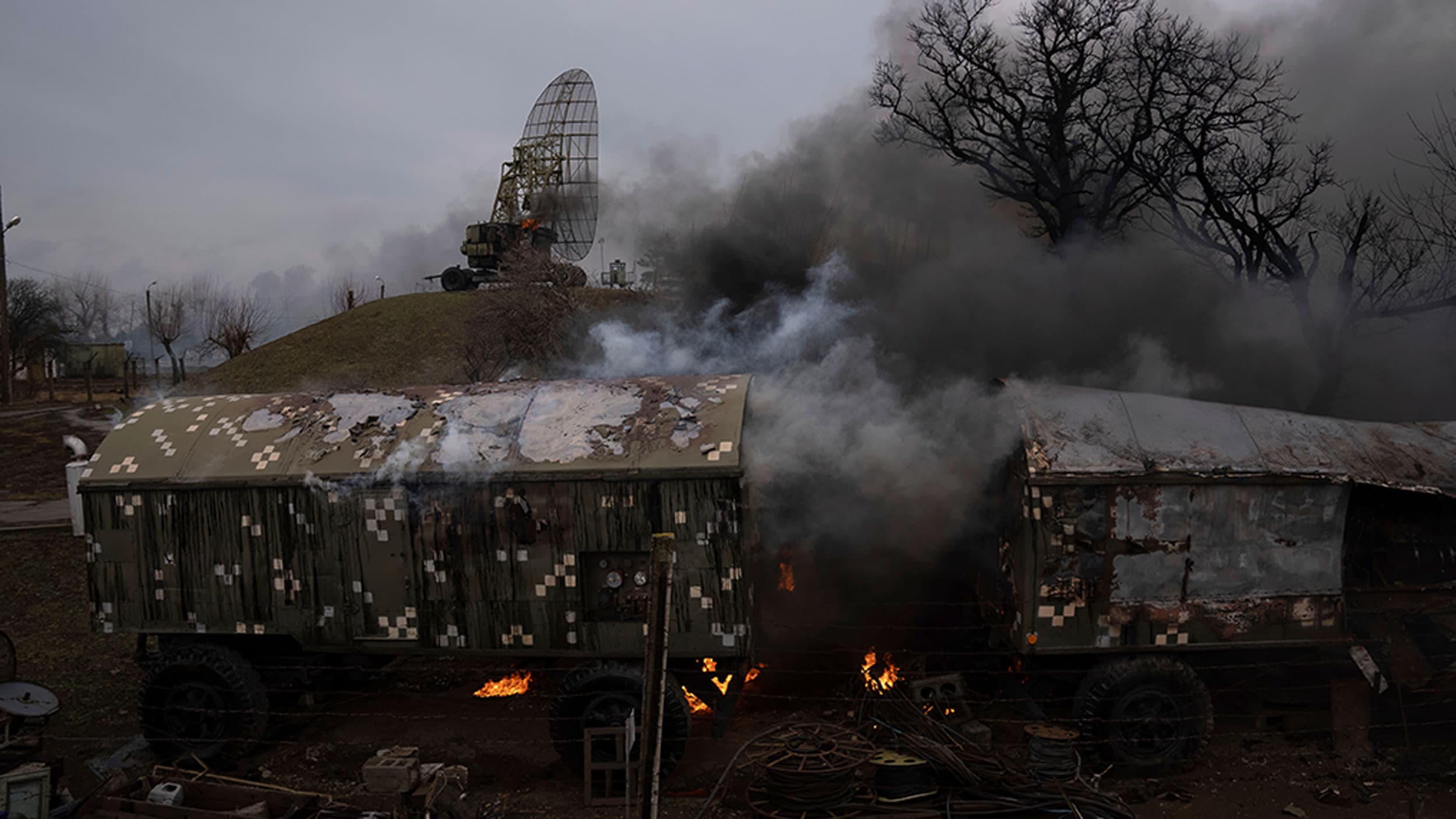 Smoke rise from an air defense base in the aftermath of an apparent Russian strike in Mariupol, Ukraine, Feb. 24, 2022.