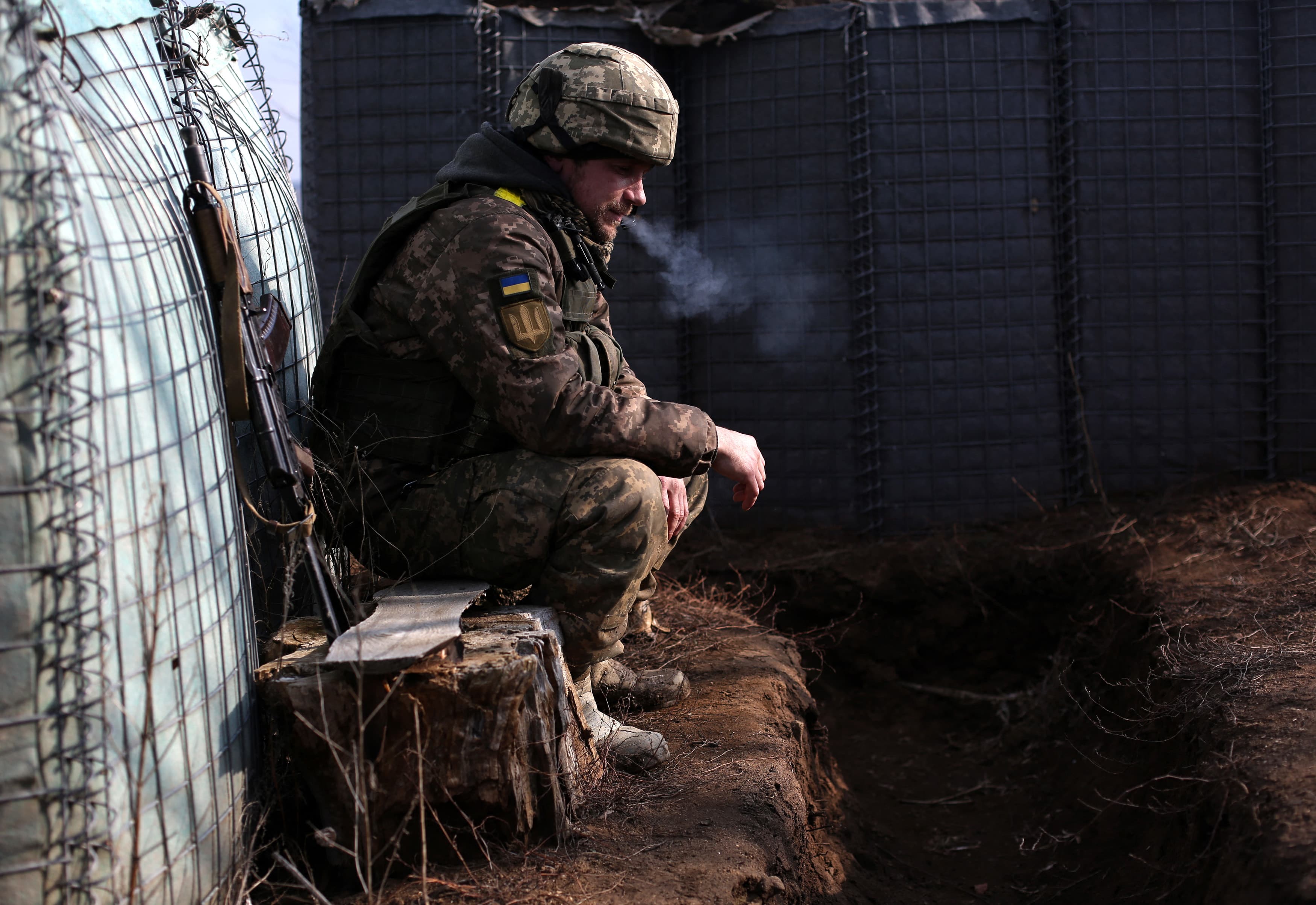 A Ukrainian soldier smokes a cigarette near the front line with Russia-backed separatists in Lugansk, Ukraine, on Feb. 22, 2022.
