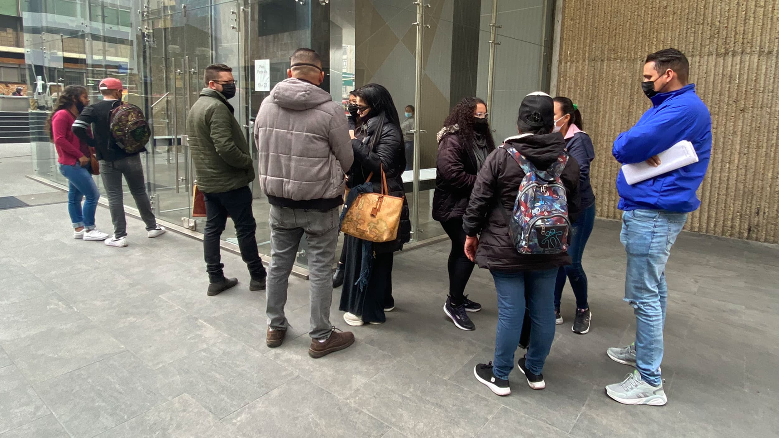 Yessika Godoy waits in line outside a government office in Bogotá, Colombia, where she's trying to get her ID card restored.