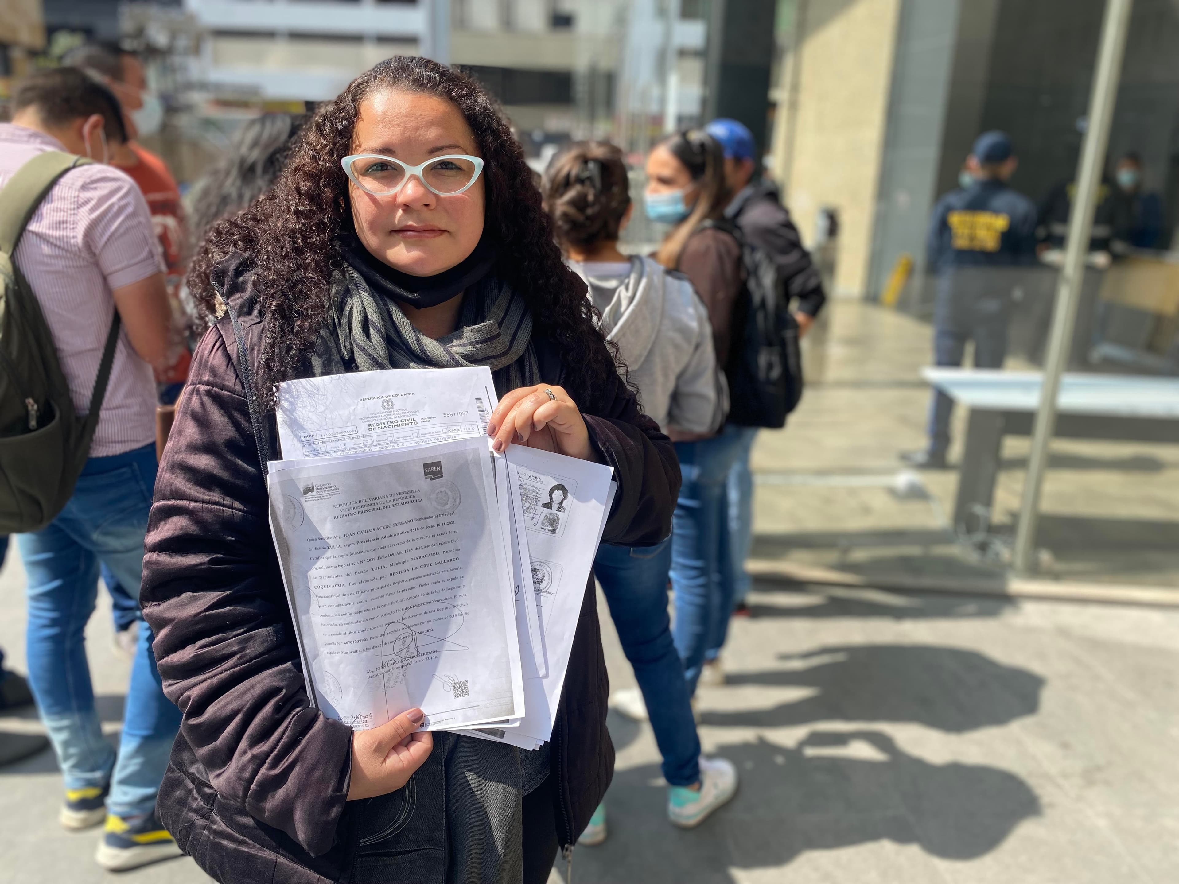 Yessika Godoy holds a photocopy of her national ID card, which was canceled in January.