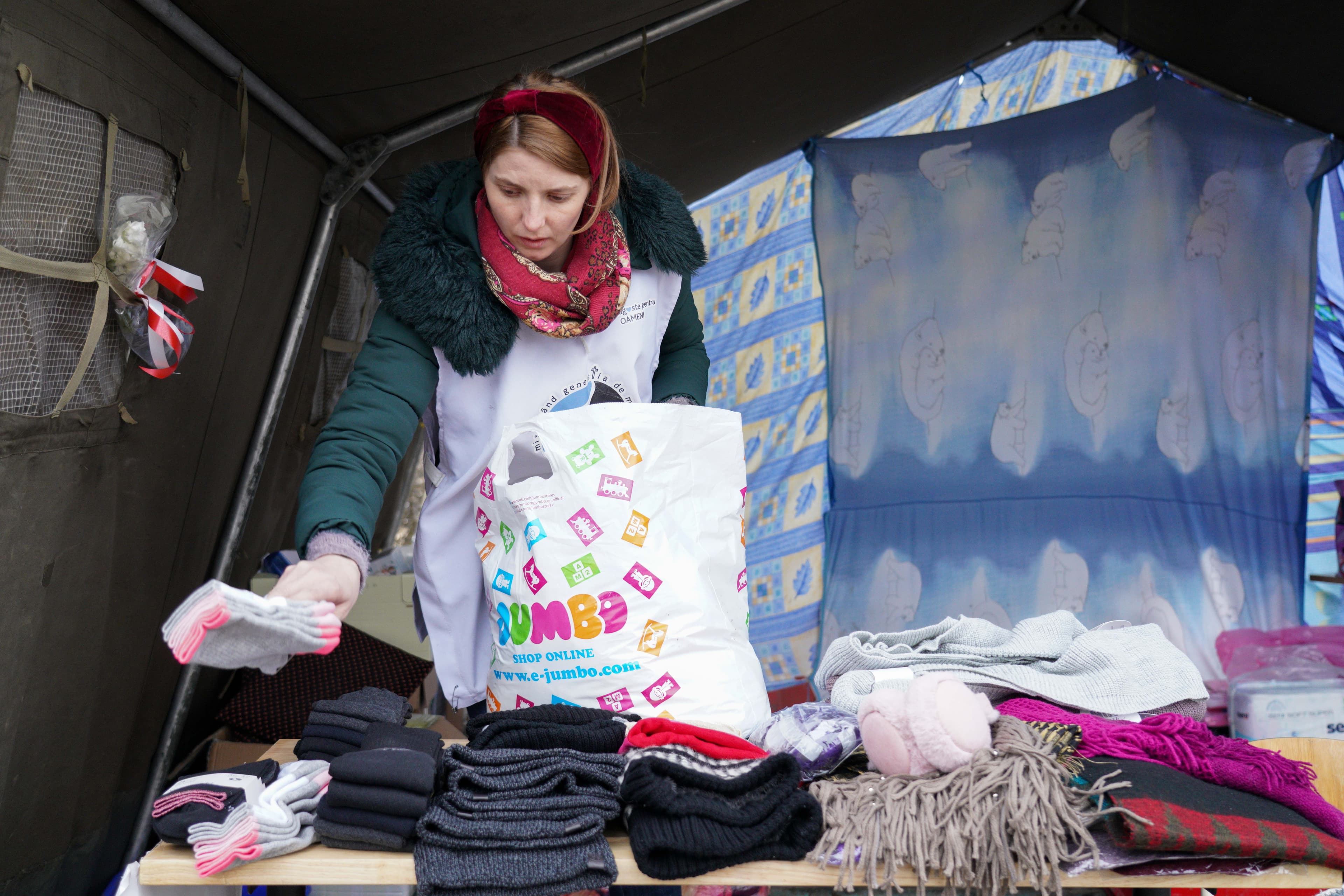 At Siret customs at the border crossing point near the town of Suceava, in northern Romania, volunteers hand out supplies to Ukrainian refugees.