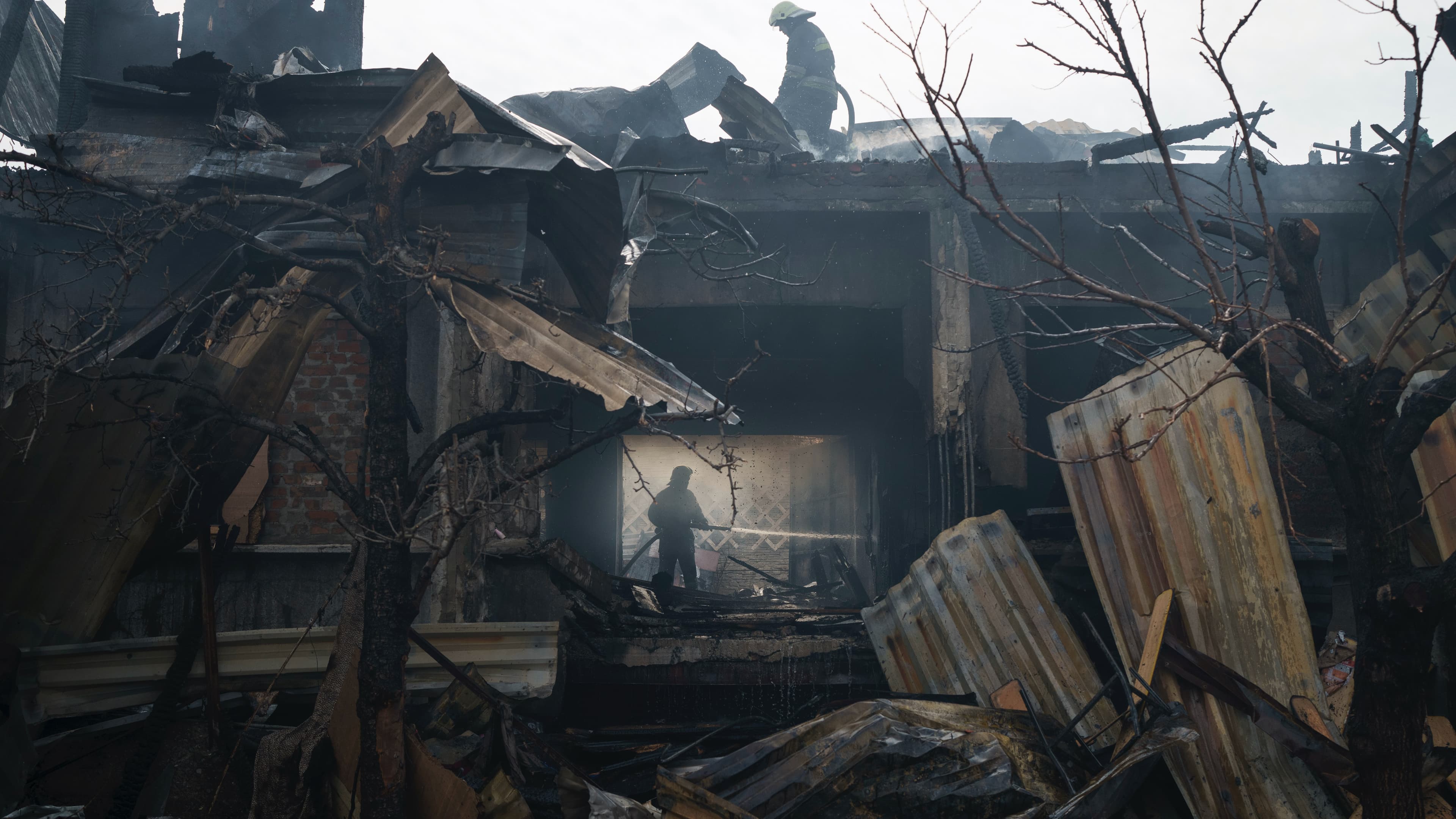 Firefighters work to extinguish a fire at a house after a Russian attack in Kharkiv, Ukraine, April 11, 2022.
