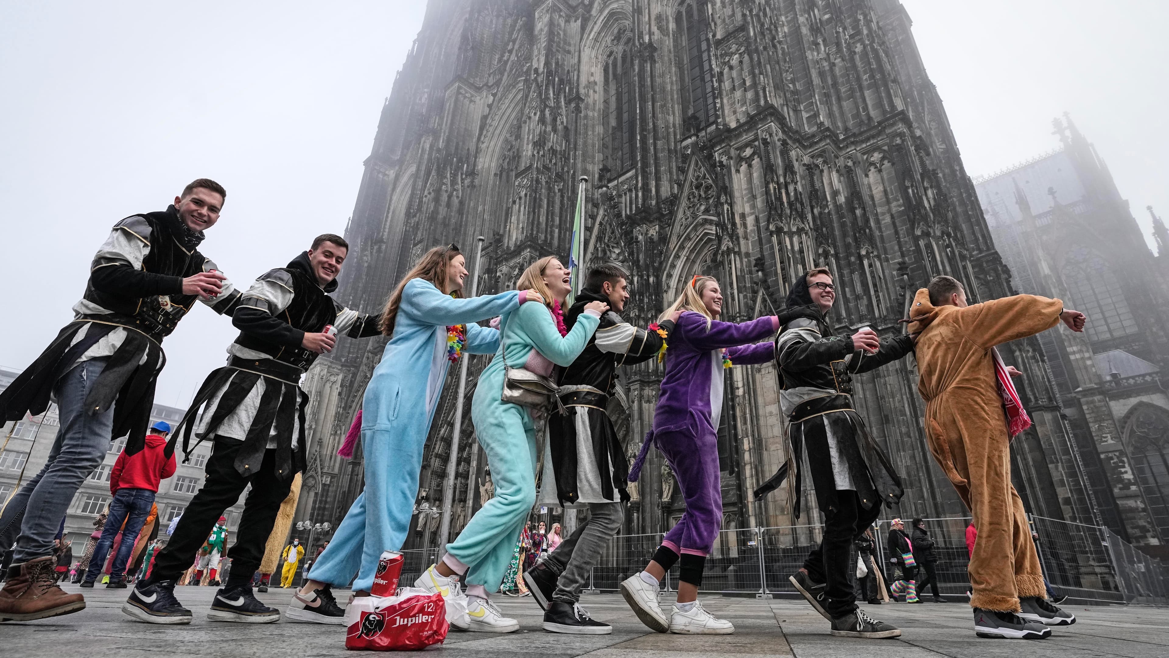 line of dancers in front of a church