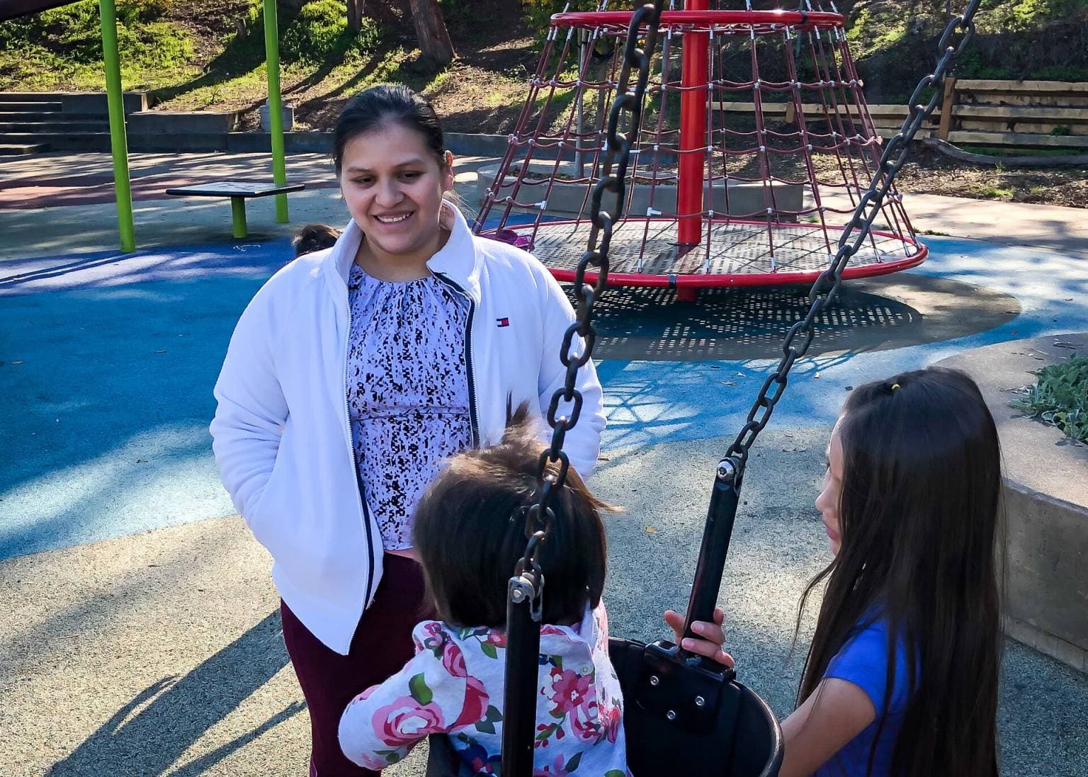 Deisy Ramírez watches her children play at a playground in San Francisco