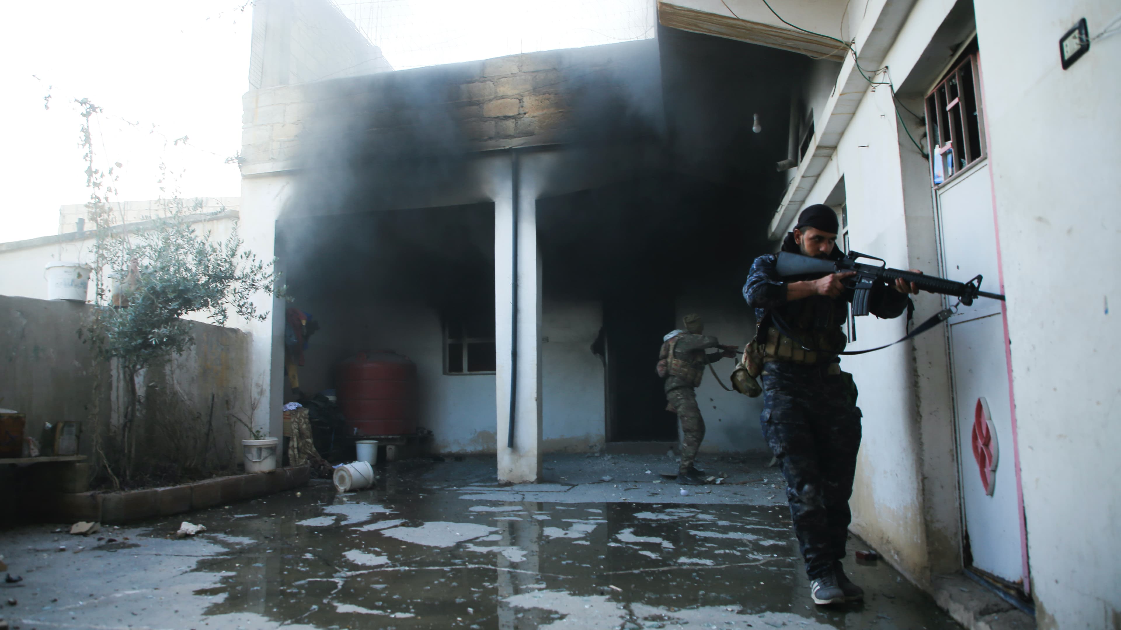 Soldiers with the US-backed Syrian Democratic Forces check a house in Hassakeh, Syria, Jan. 25, 2022. After breaking into the prison late Thursday, ISIS militants were joined by others rioting inside the facility that housed over 3,000 inmates, including