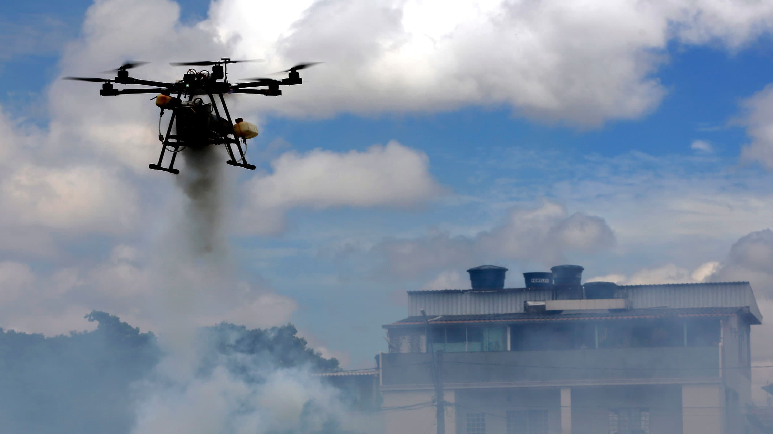 A drone sprays insecticide near homes on the outskirts of Brasilia, Brazil, Tuesday, Nov. 24, 2020. Brazil's health ministry launched a campaign to fight the Aedes aegypti mosquito, which transmits dengue, zika and chikungunya, diseases that can generate