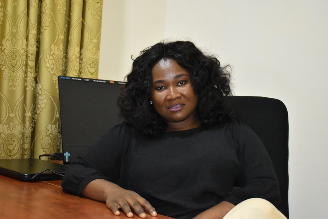 portrait of a woman next to a computer