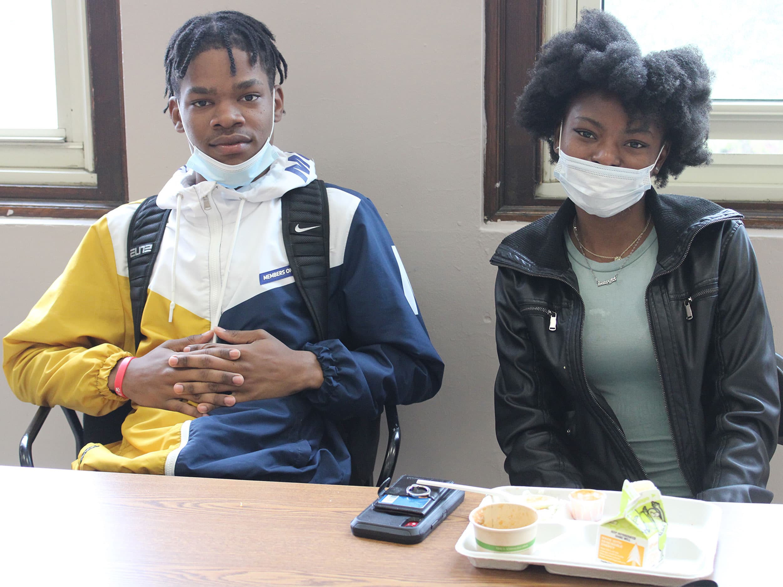 two kids sit at a table